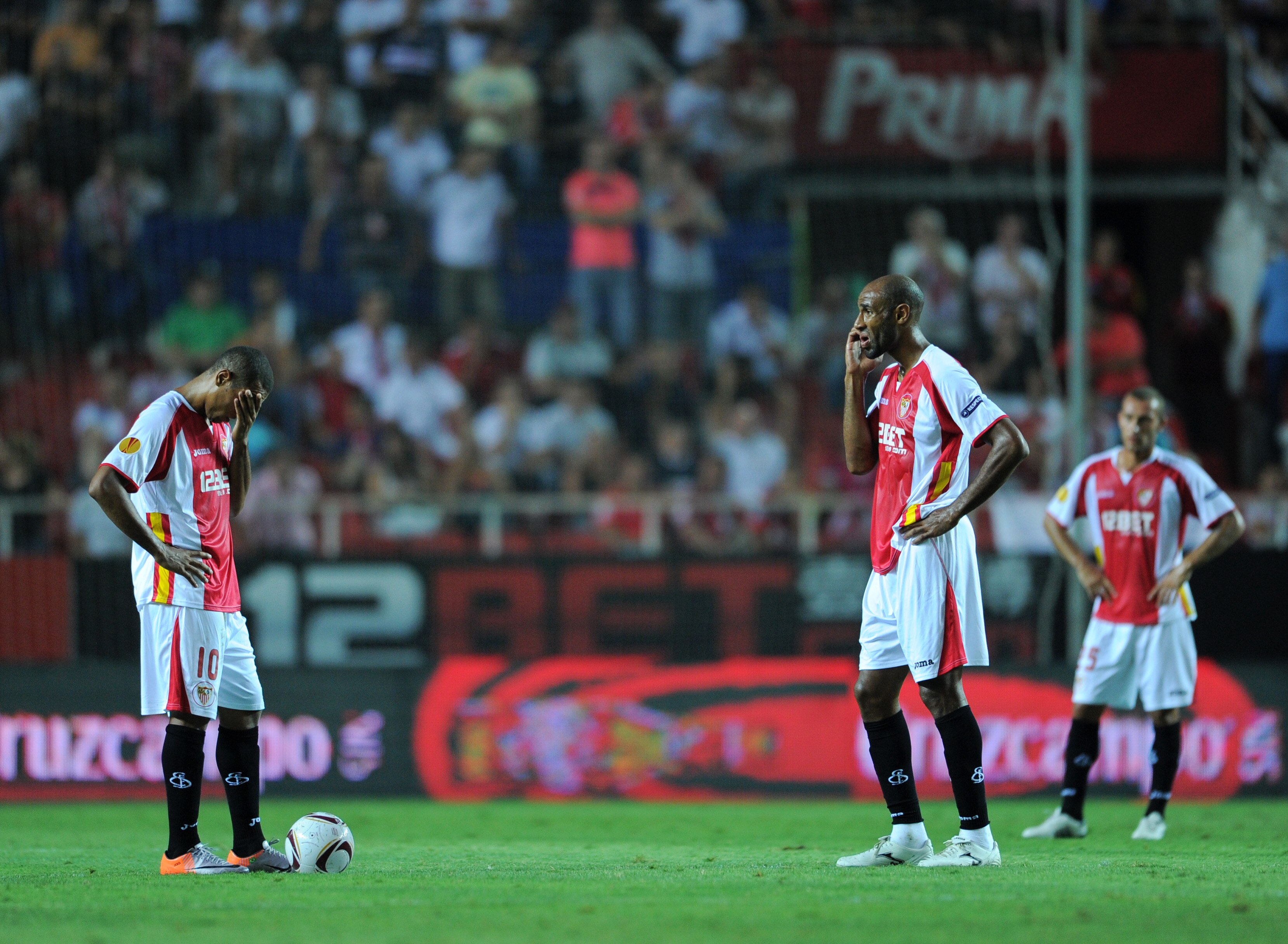 SEVILLE, SPAIN - SEPTEMBER 16:  Luis Fabiano (L) of Sevilla stands dejected with his teammate Frederic Kanoute waiting to resume the game after conceding a goal during the UEFA Europa League group J match between Sevilla and Paris Saint Germain at the Est