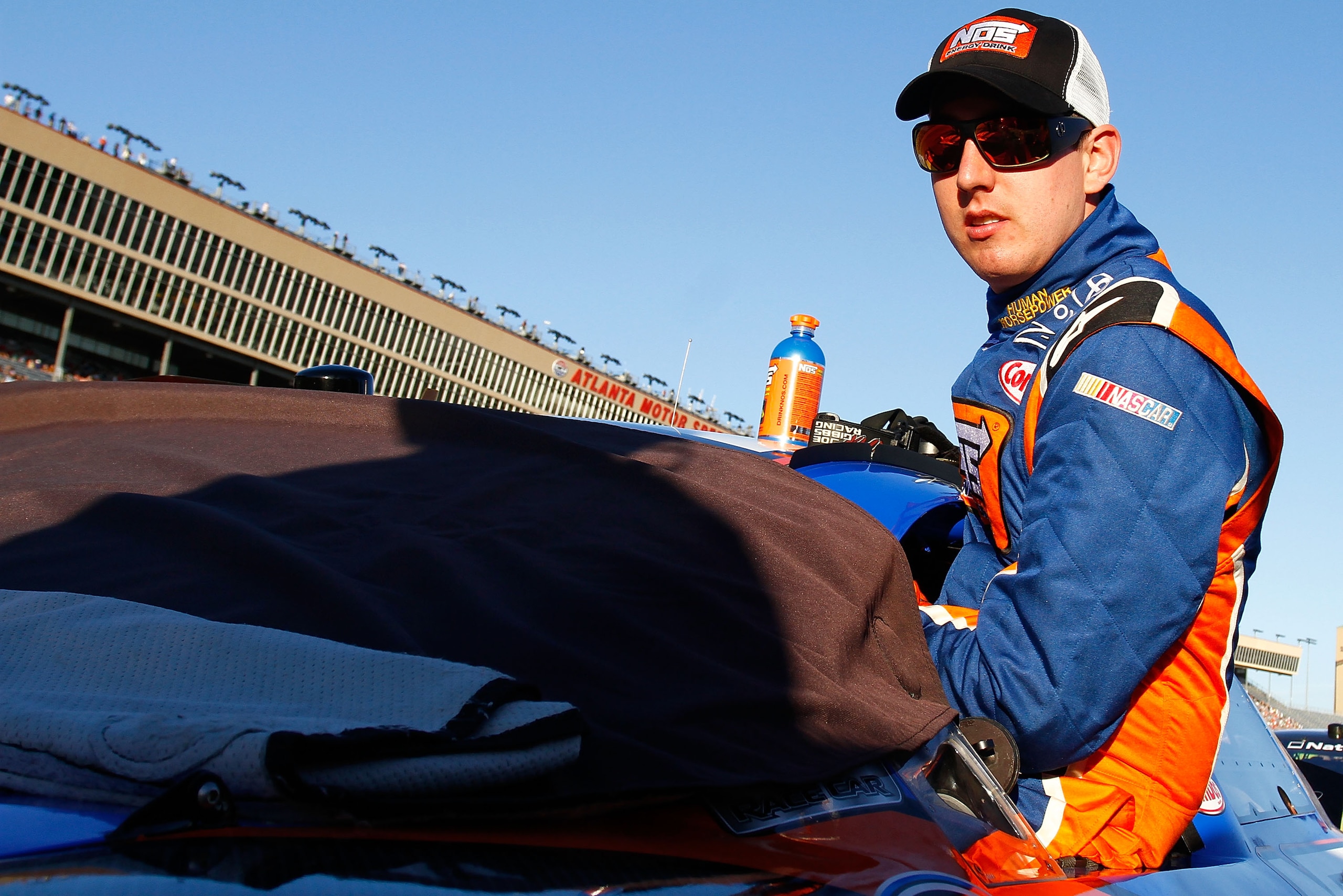 HAMPTON, GA - SEPTEMBER 04:  Kyle Busch, driver of the #18 NOS Energy Drink Toyota, climbs in his car prior to the start of the NASCAR Nationwide Series Great Clips 300 at Atlanta Motor Speedway on September 4, 2010 in Hampton, Georgia.  (Photo by Jason S