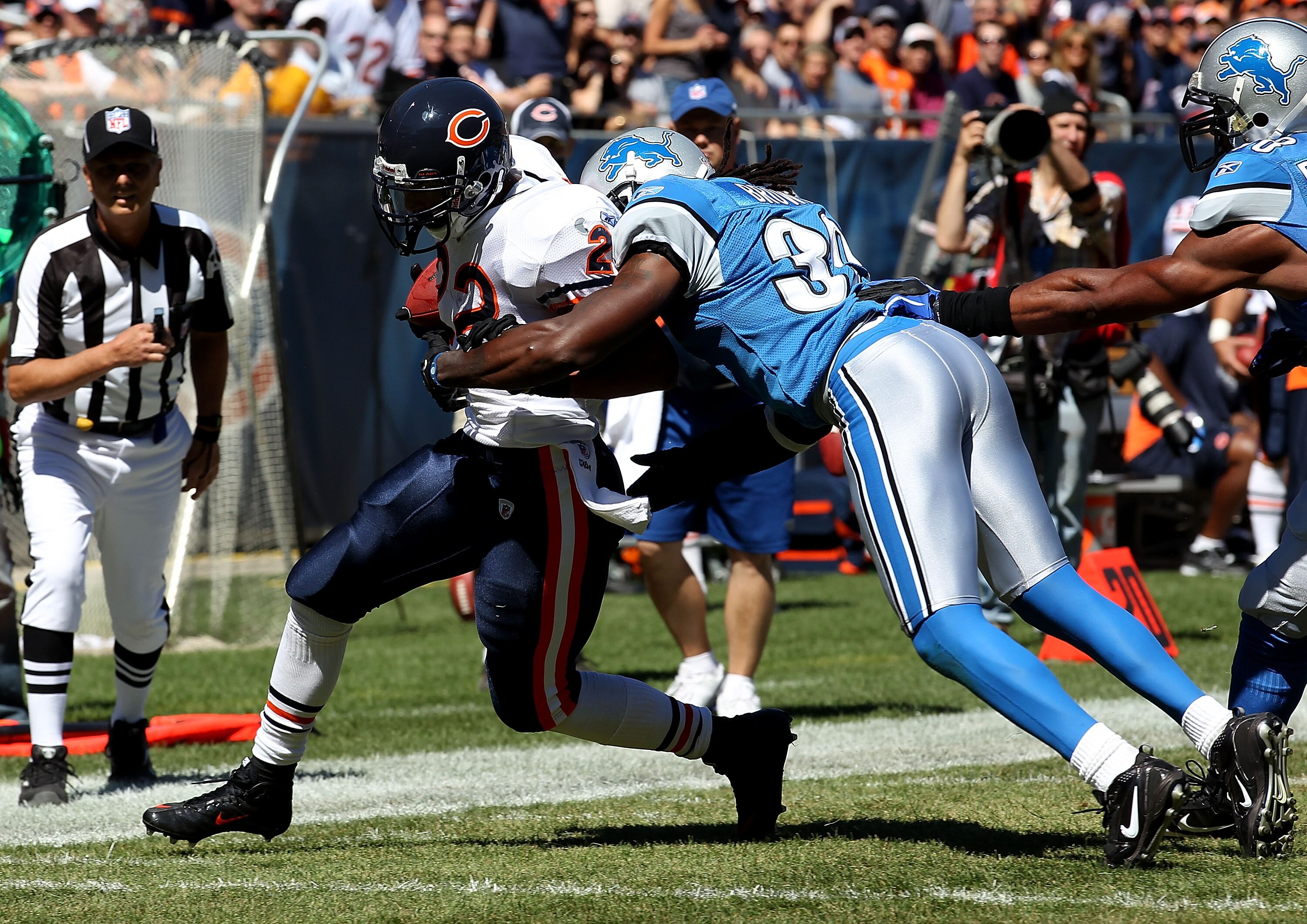 CHICAGO - SEPTEMBER 12: Matt Forte #22 of the Chicago Bears is hit by Aaron Berry #32 of the Detroit Lions during the NFL season opening game at Soldier Field on September 12, 2010 in Chicago, Illinois. The Bears defeated the Lions 19-14. (Photo by Jonath