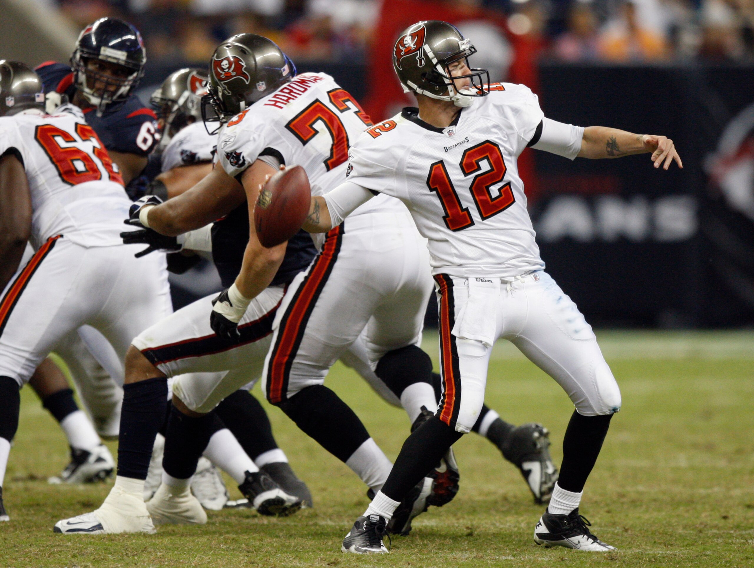 HOUSTON - SEPTEMBER 02:  Quarterback Rudy Carpenter #12 of the Tampa Bay Buccaneers stands in the pocket as he looks downfield for a receiver against the Houston Texans at Reliant Stadium on September 2, 2010 in Houston, Texas.  (Photo by Bob Levey/Getty