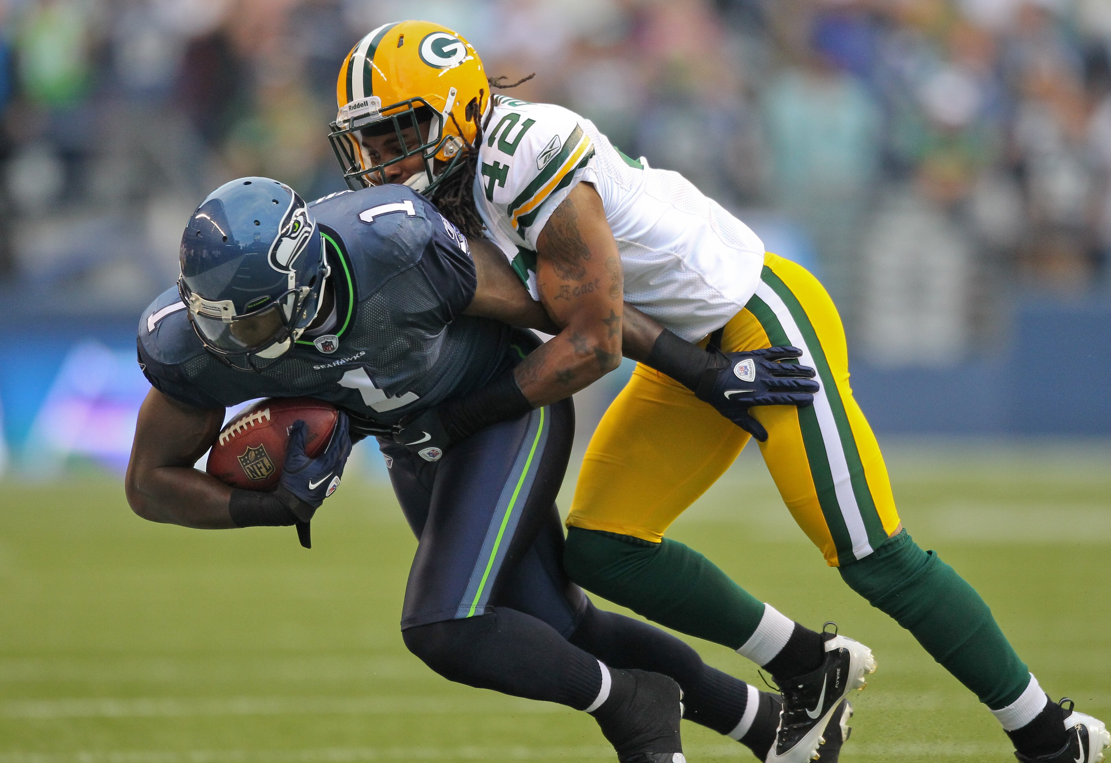 SEATTLE - AUGUST 21: Wide receiver Mike Williams #1 of the Seattle Seahawks is tackled during the preseason game by Morgan Burnett #42 of the Green Bay Packers at Qwest Field on August 21, 2010 in Seattle, Washington. (Photo by Otto Greule Jr/Getty Image SEATTLE - AUGUST 21: Wide receiver Mike Williams #1 of the Seattle Seahawks is tackled during the preseason game by Morgan Burnett #42 of the Green Bay Packers at Qwest Field on August 21, 2010 in Seattle, Washington. (Photo by Otto Greule Jr/Getty Image