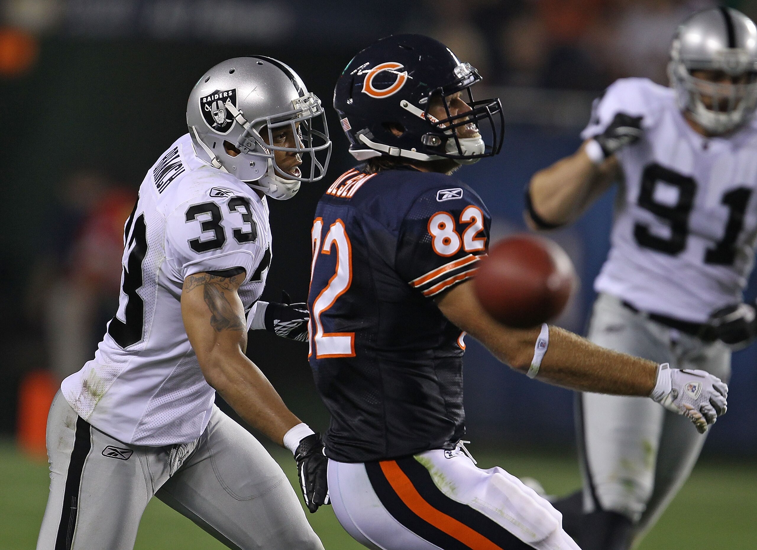 CHICAGO - AUGUST 21: Tyvon Branch #33 of the Oakland Raiders breaks up a pass intended for Greg Olsen #82 of the Chicago Bears during a preseason game at Soldier Field on August 21, 2010 in Chicago, Illinois. The Raiders defeated the Bears 32-17. (Photo b