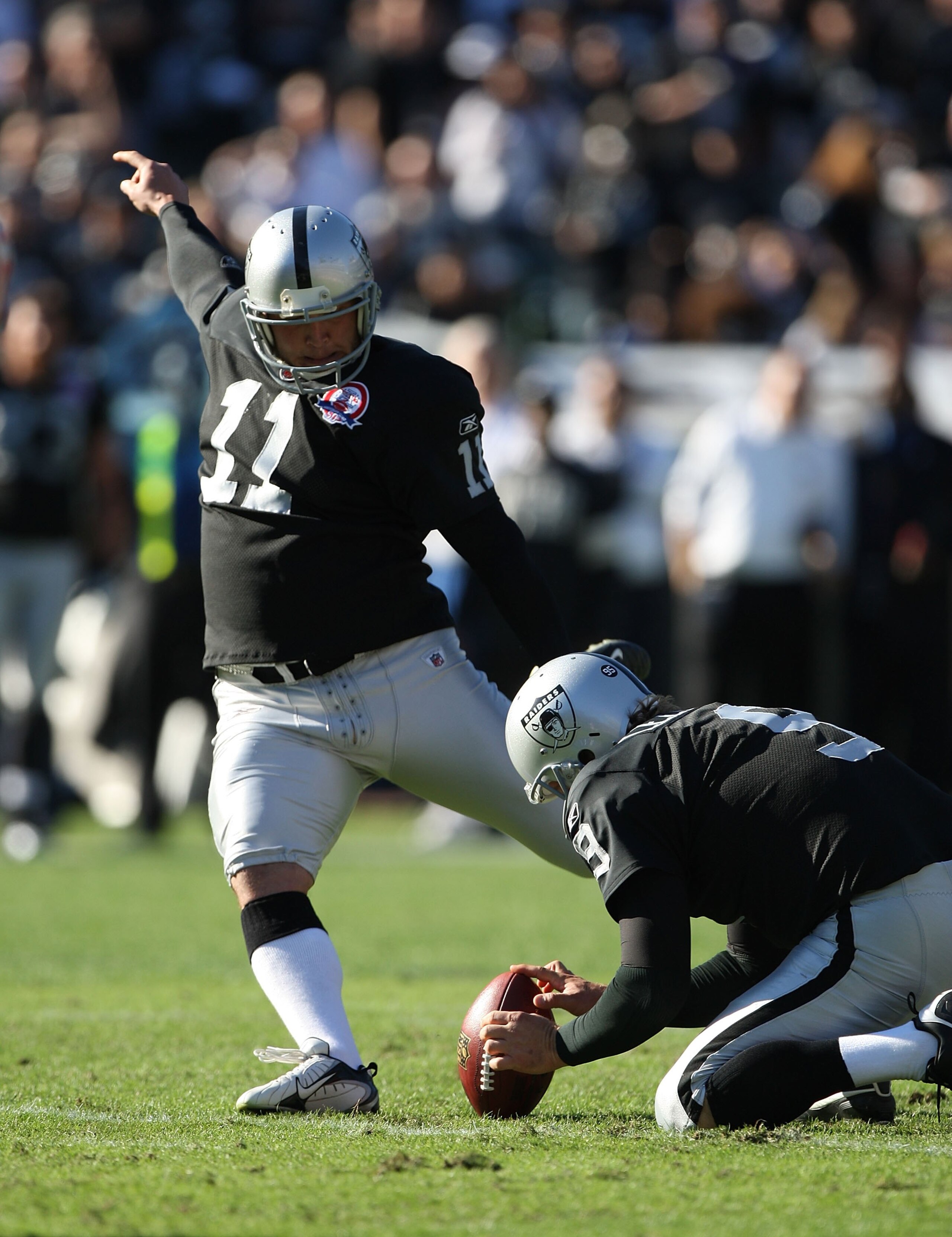 OAKLAND, CA - NOVEMBER 15:  Sebastian Janikowski #11 of the Oakland Raiders kicks against the Kansas City Chiefs during an NFL game at Oakland-Alameda County Coliseum on November 15, 2009 in Oakland, California.  (Photo by Jed Jacobsohn/Getty Images)