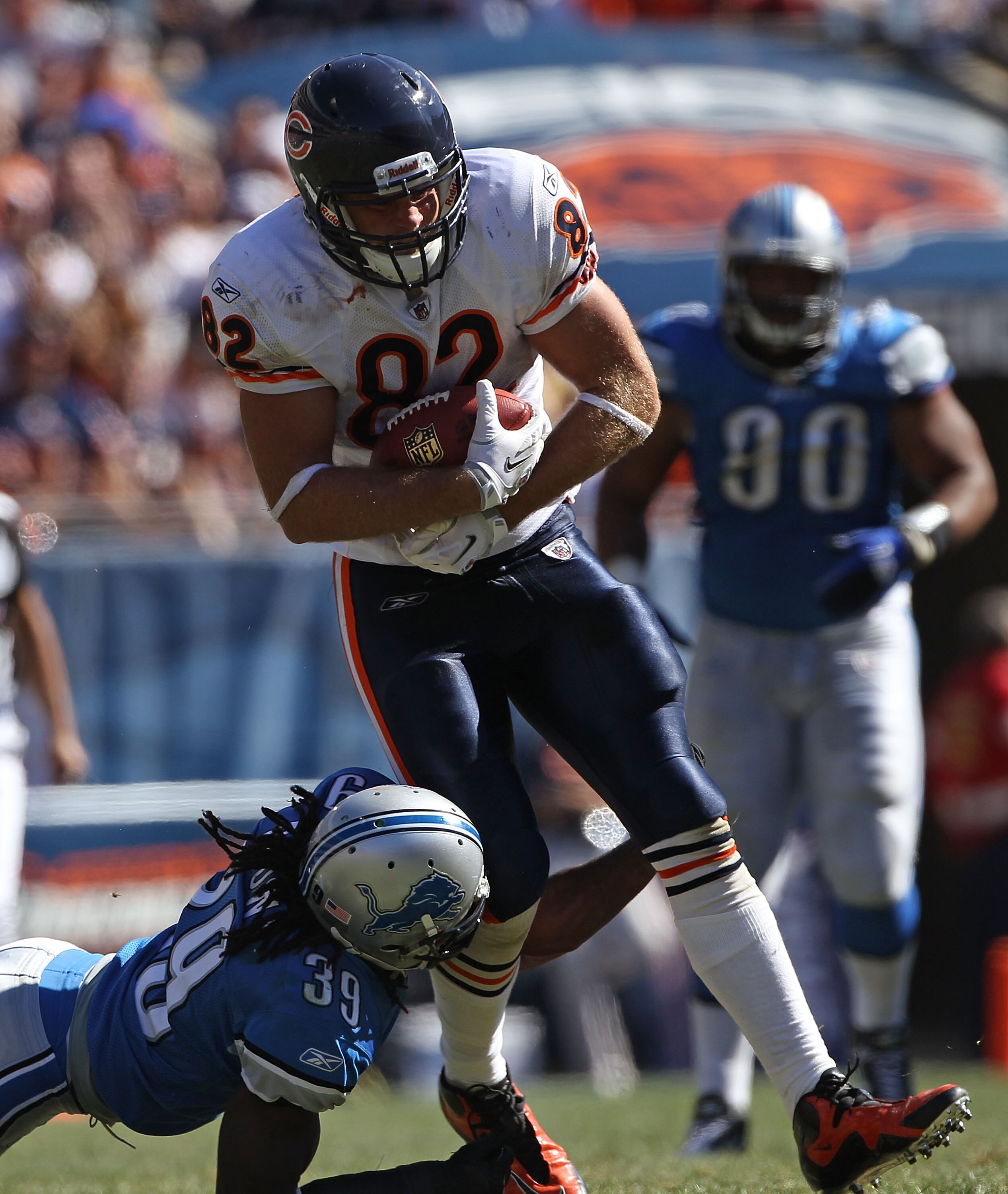 CHICAGO - SEPTEMBER 12: Greg Olsen #82 of the Chicago Bears grabs a pass for a first down as C.C. Brown #39 of the Detroit Lions goes for the tackle during the NFL season opening game at Soldier Field on September 12, 2010 in Chicago, Illinois. The Bears
