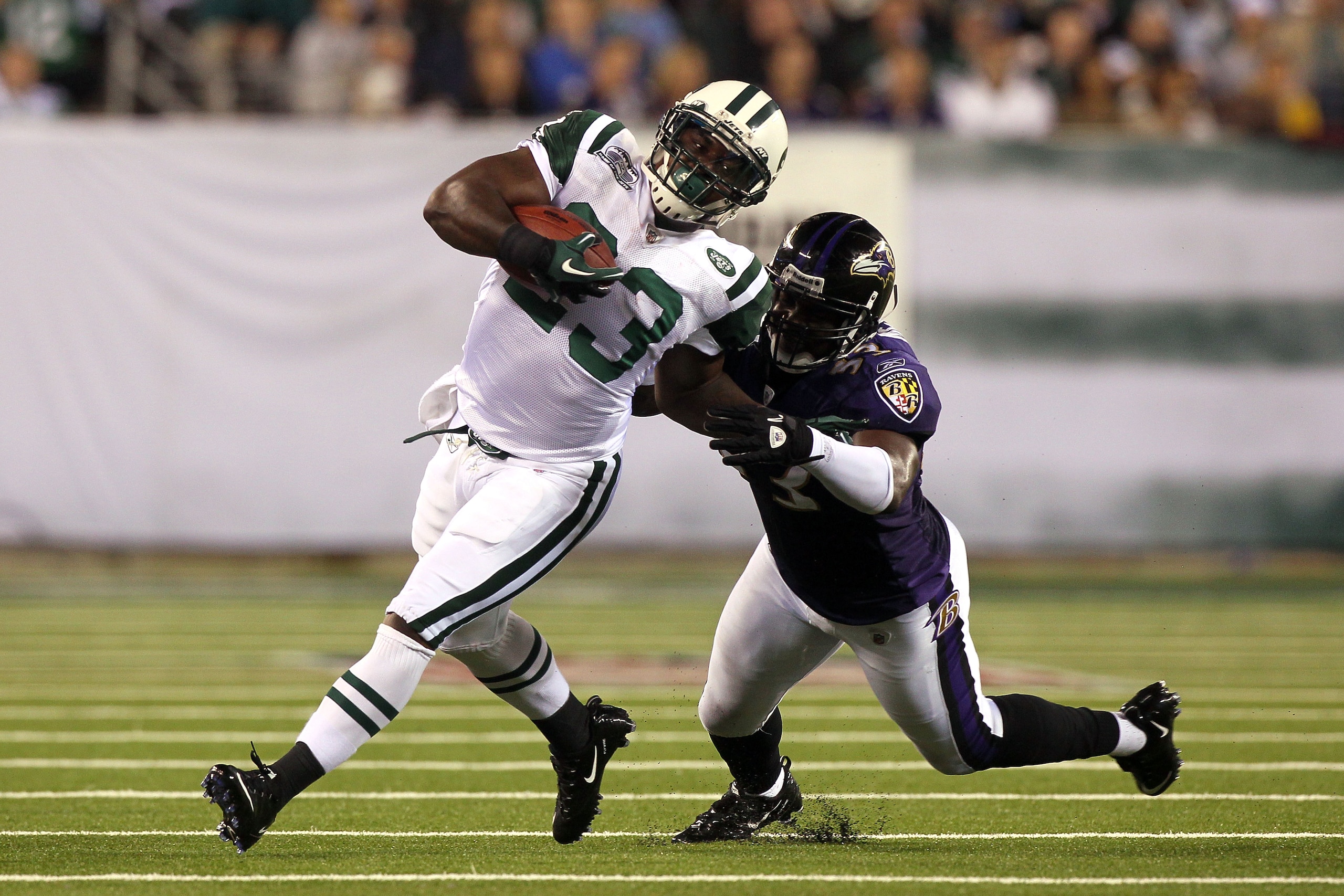 EAST RUTHERFORD, NJ - SEPTEMBER 13:  Shonn Greene #23 of the New York Jets gets tackeled by Jameel McClain #53 of the Baltimore Ravens during their home opener at the New Meadowlands Stadium on September 13, 2010 in East Rutherford, New Jersey.  (Photo by