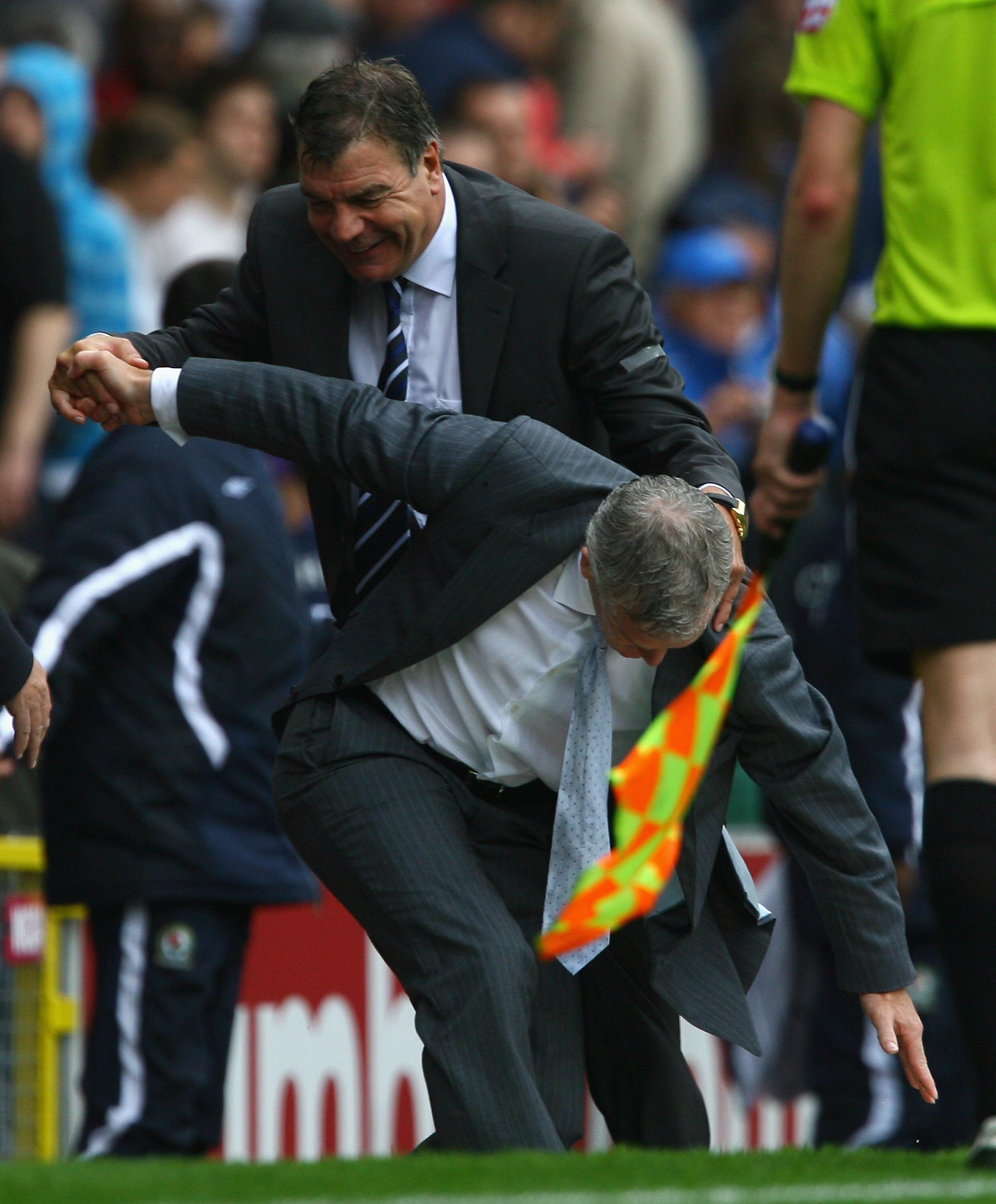 BLACKBURN, ENGLAND - AUGUST 15:  Blackburn Rovers Manager Sam Allardyce holds on to Manchester City Manager Mark Hughes as he takes a tumble at the end of the Barclays Premier League match between Blackburn Rovers and Manchester City at Ewood Park on Augu
