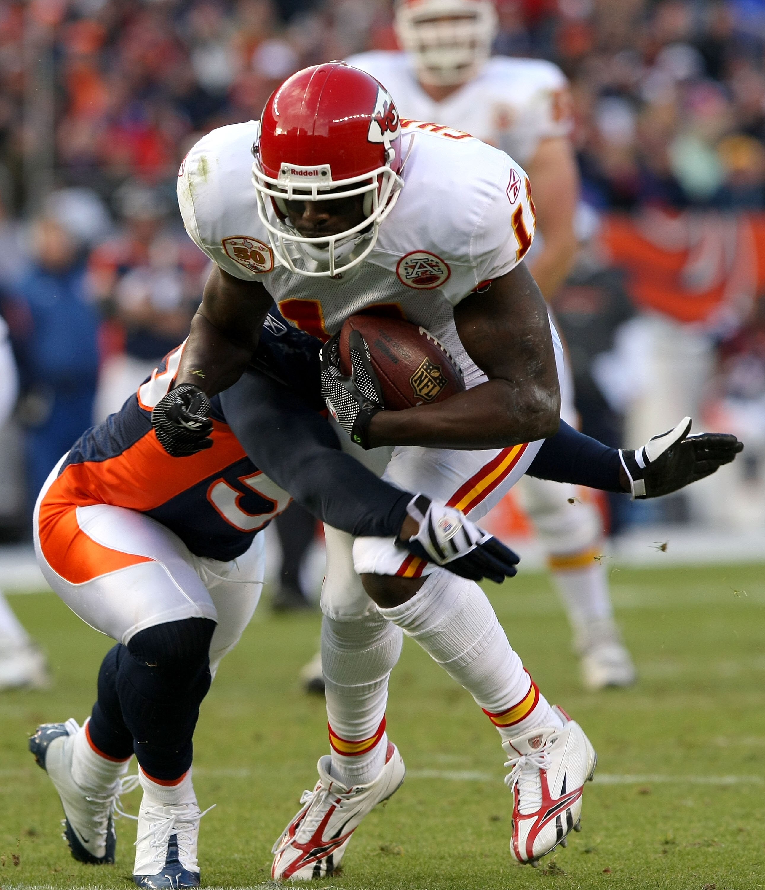DENVER - JANUARY 03: Chris Chambers #11 of the Kansas City Chiefs makes a first down reception to the two yard line as D.J. Williams #55 of the Denver Broncos makes the tackle during NFL action at Invesco Field at Mile High on January 3, 2010 in Denver, C