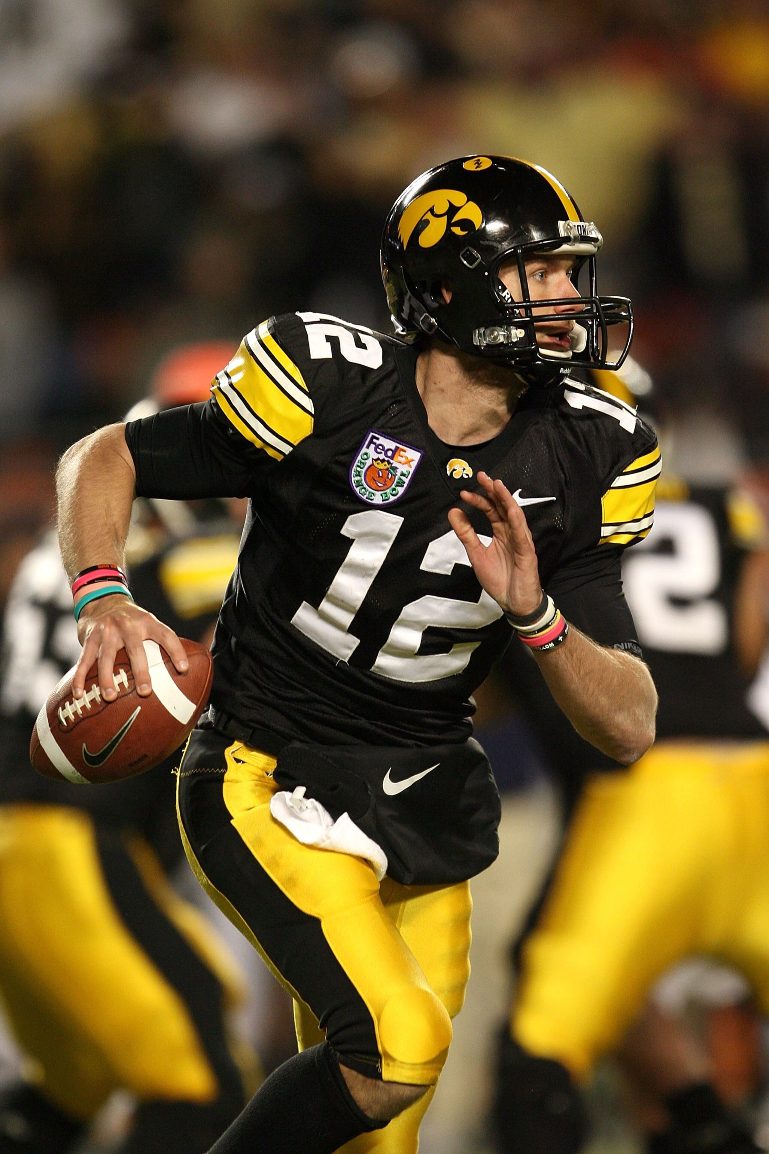 MIAMI GARDENS, FL - JANUARY 05:  Quarterback Ricky Stanzi #12 of the Iowa Hawkeyes rolls out to pass against the Georgia Tech Yellow Jackets during the FedEx Orange Bowl at Land Shark Stadium on January 5, 2010 in Miami Gardens, Florida. Iowa won 24-14.  