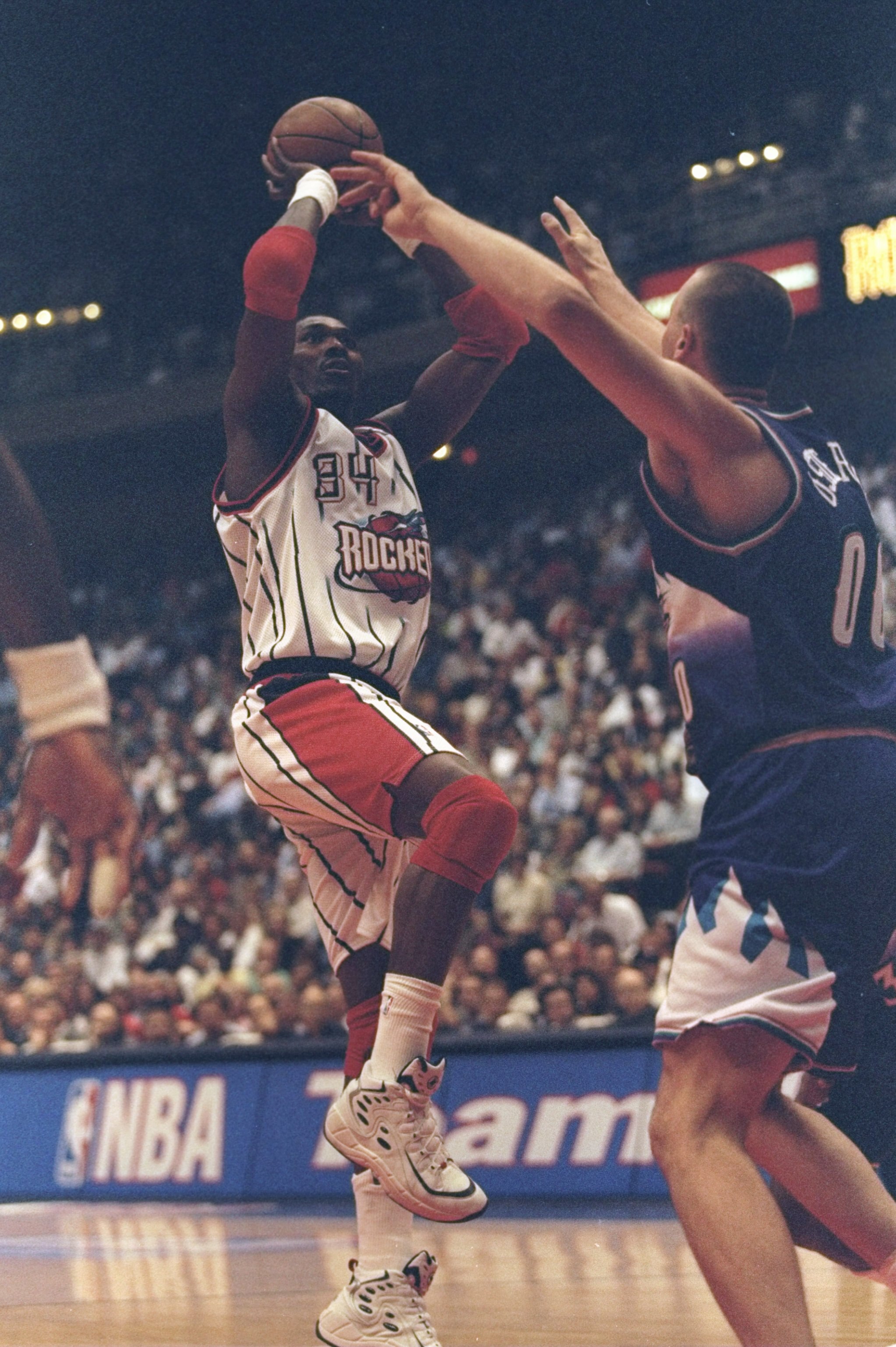 30 Apr 1998: Hakeem Olajuwon #34 of the Houston Rockets in action against Greg Ostertag #00 of the Utah Jazz during the Western Conference First Round Game 3 at the Compaq Center in Houston, Texas. The Rockets defeated the Jazz 89-85.