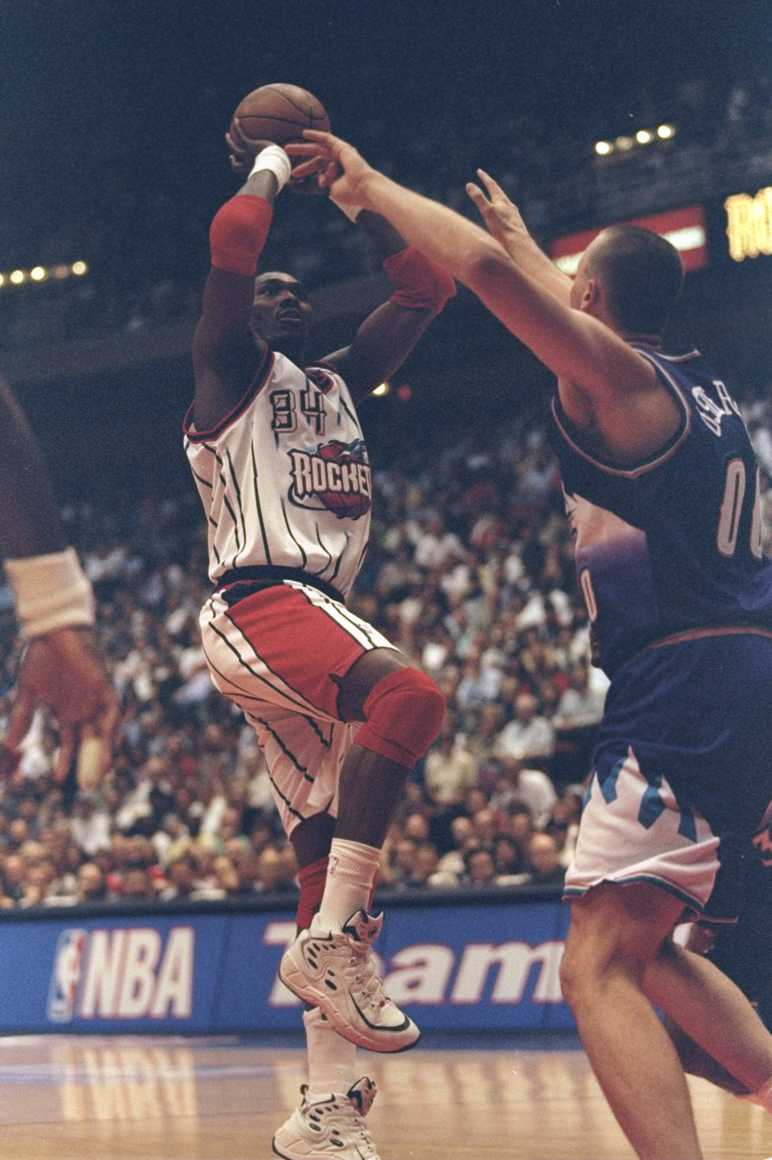 30 Apr 1998: Hakeem Olajuwon #34 of the Houston Rockets in action against Greg Ostertag #00 of the Utah Jazz during the Western Conference First Round Game 3 at the Compaq Center in Houston, Texas. The Rockets defeated the Jazz 89-85. 30 Apr 1998: Hakeem Olajuwon #34 of the Houston Rockets in action against Greg Ostertag #00 of the Utah Jazz during the Western Conference First Round Game 3 at the Compaq Center in Houston, Texas. The Rockets defeated the Jazz 89-85.