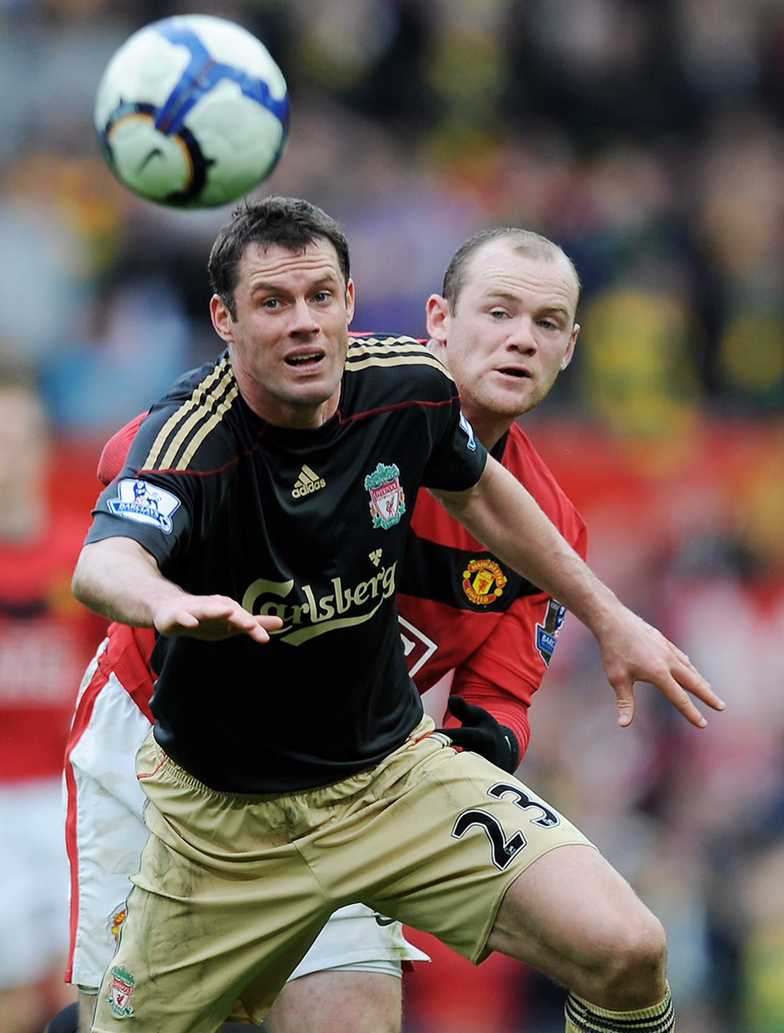 MANCHESTER, ENGLAND - MARCH 21:  Wayne Rooney of Manchester United battles with Jamie Carragher of Liverpool during the Barclays Premier League match between Manchester United and Liverpool at Old Trafford on March 21, 2010 in Manchester, England.  (Photo
