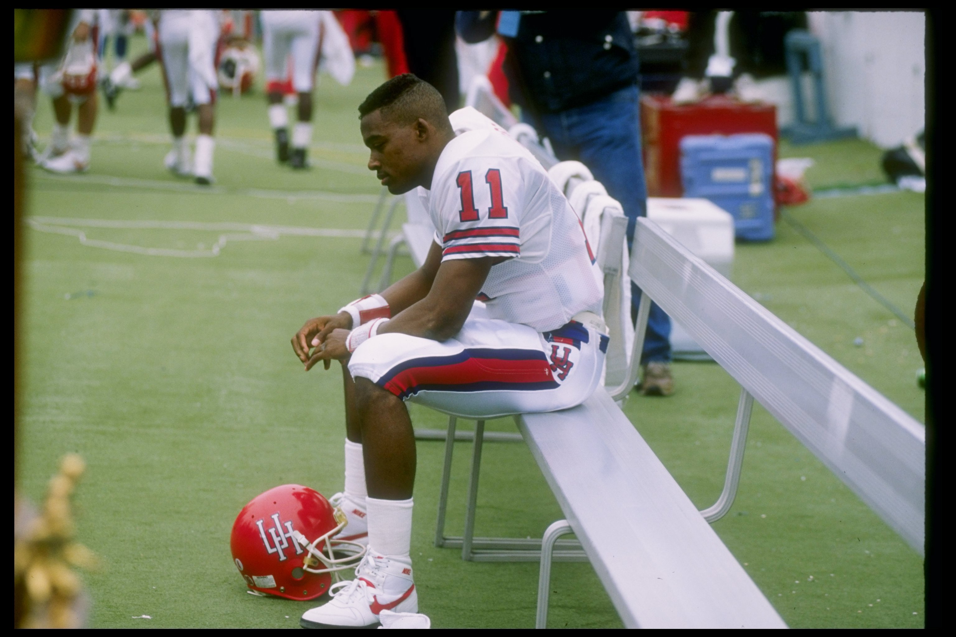 2 Dec 1989: Quarterback Andre Ware #11 of the Houston Cougars looks on during a game against the Rice Owls in Houston, Texas. The Houston Cougars won the game 64-0.