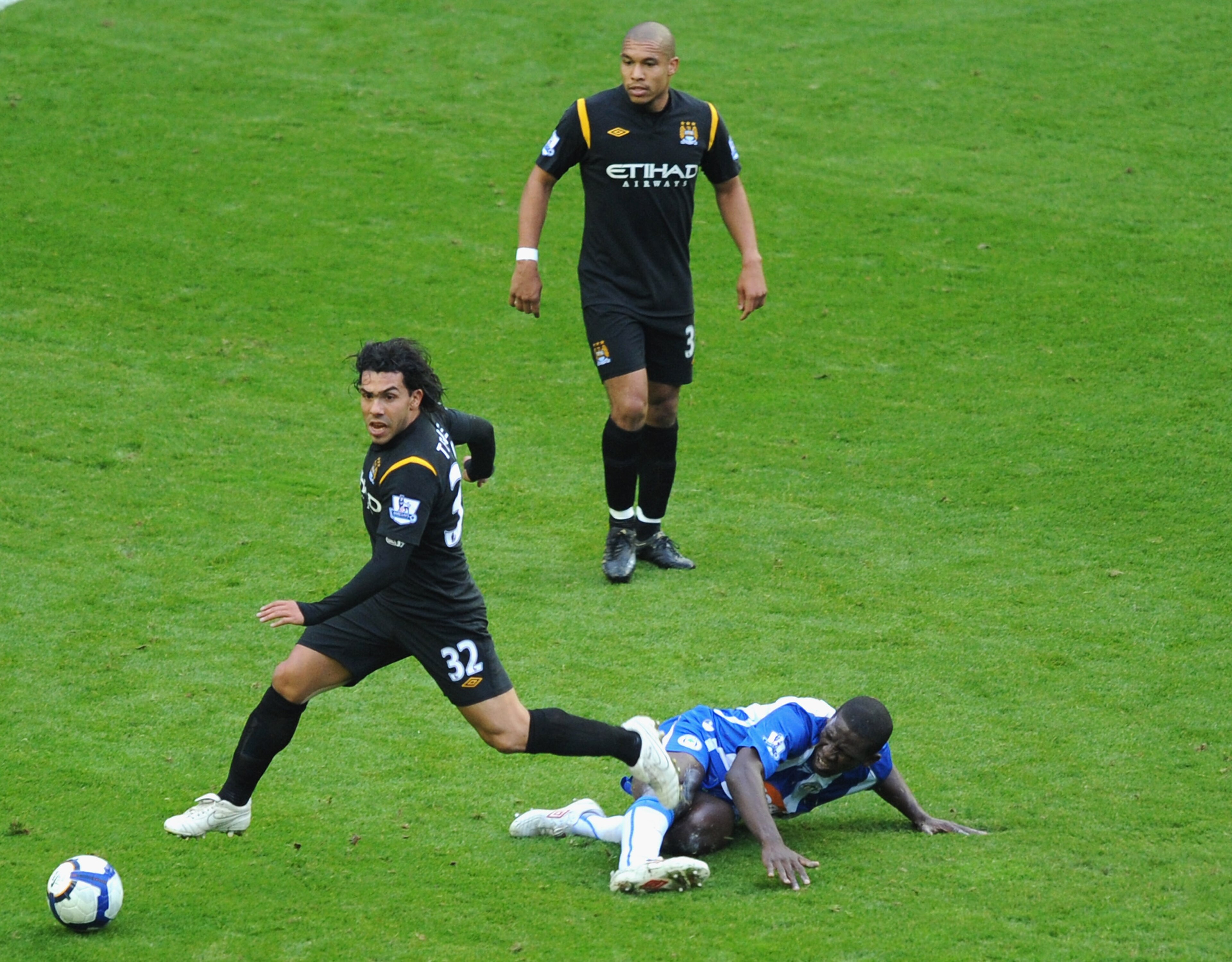 WIGAN, ENGLAND - OCTOBER 18: Carlos Tevez  of Manchester City battles with Mohamed Diame of Wigan during the Barclays Premiership match between Wigan Athletic and Manchester City at The DW Stadium on October 18, 2009 in Wigan, England.  (Photo by Laurence