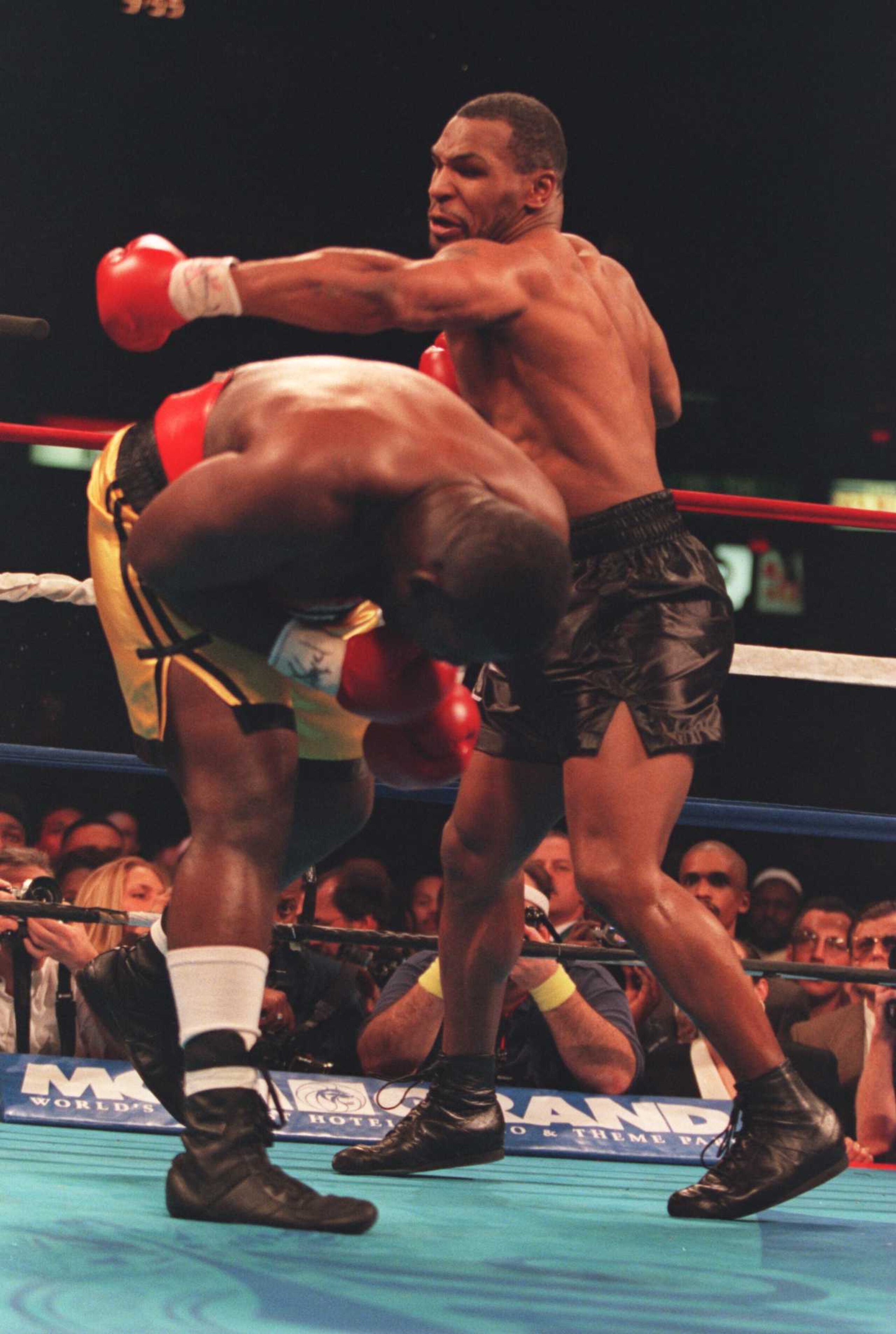 16 DEC 1995: MIKE TYSON SWINGS AT BUSTER MATHIS JNR ON HIS WAY TO KNOCKING HIM OUT IN THE THIRD ROUND OF THEIR FIGHT AT THE CORESTATES SPECTRUM IN PHILADELPHIA, PENNSYLVANIA. Mandatory Credit: Simon Bruty/ALLSPORT