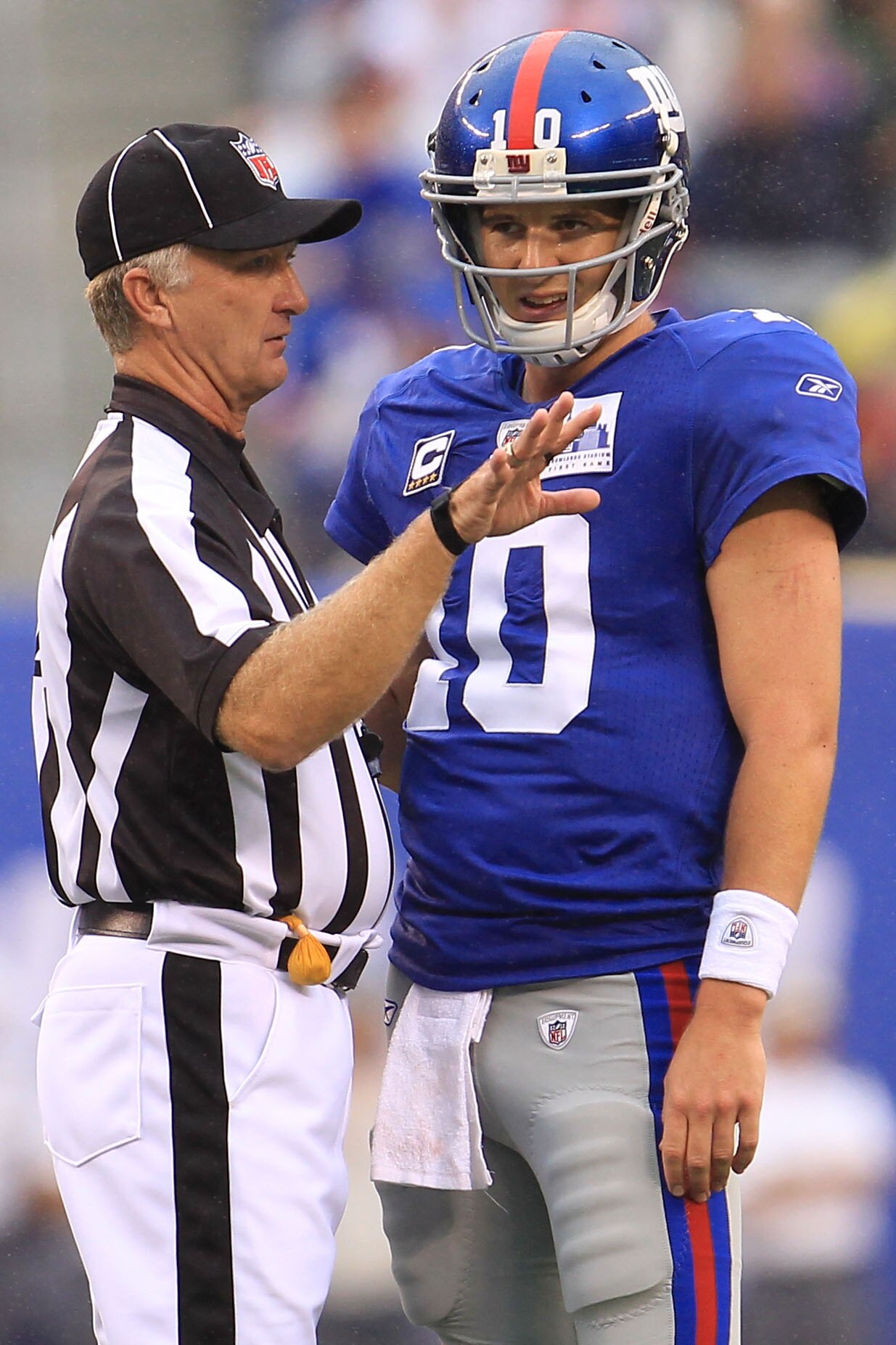 EAST RUTHERFORD, NJ - SEPTEMBER 12:  Eli Manning #10 of the New York Giants talks with the referee against the Carolina Panthers during the NFL season opener at New Meadowlands Stadium on September 12, 2010 in East Rutherford, New Jersey.  (Photo by Chris