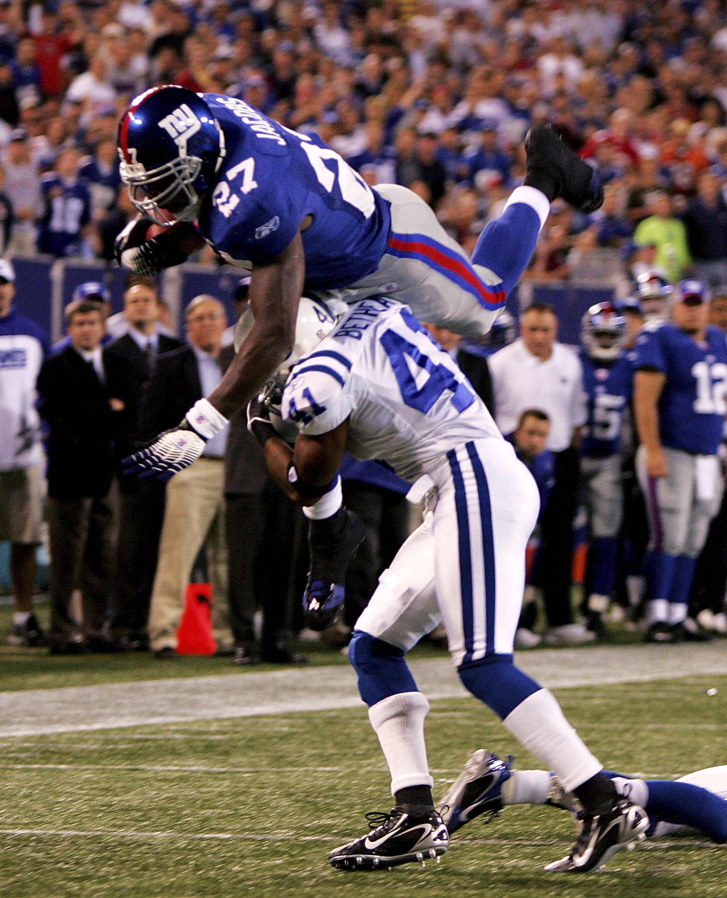 EAST RUTHERFORD, NJ - SEPTEMBER 10:  Brandon Jacobs #29 of the New York Giants dives over Antoine Bethea #41 of the Indianapolis Colts on September 10, 2006 at Giants Stadium in East Rutherford, New Jersey.  (Photo by Travis Lindquist/Getty Images)