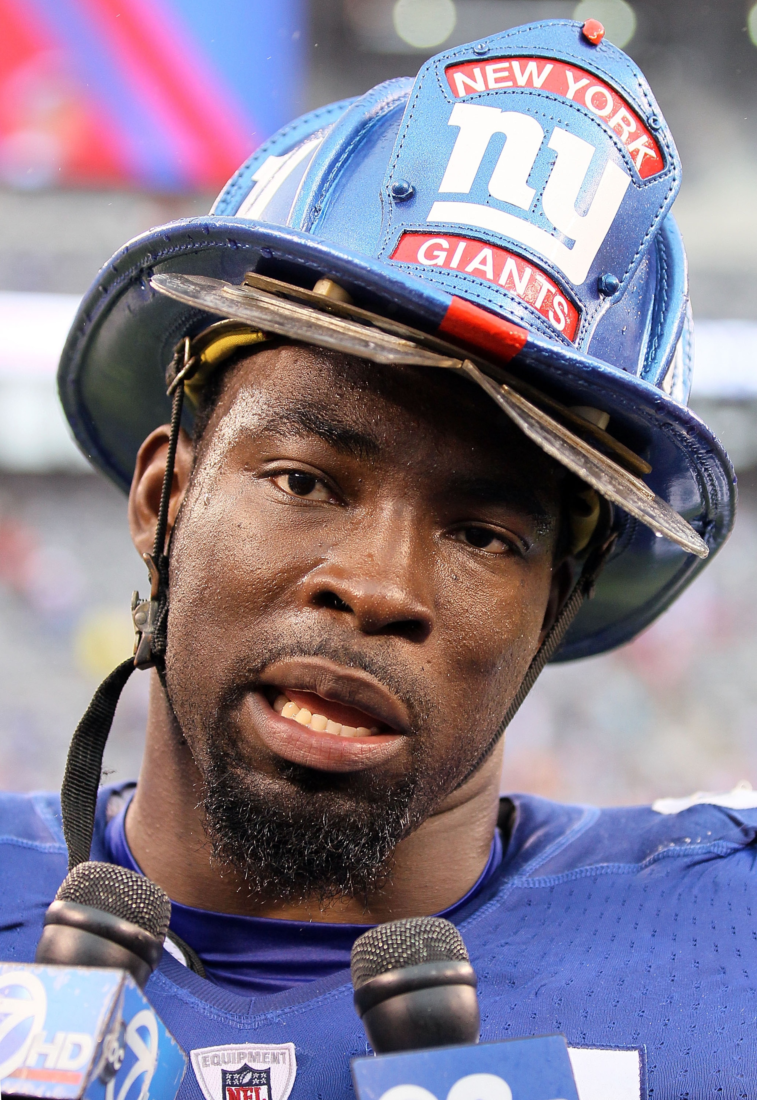 EAST RUTHERFORD, NJ - SEPTEMBER 12:  Justin Tuck #91 of the New York Giants speaks to the media on the field after defeating the Carolina Panthers on September 12, 2010 at the New Meadowlands Stadium in East Rutherford, New Jersey. The Giants defeated the