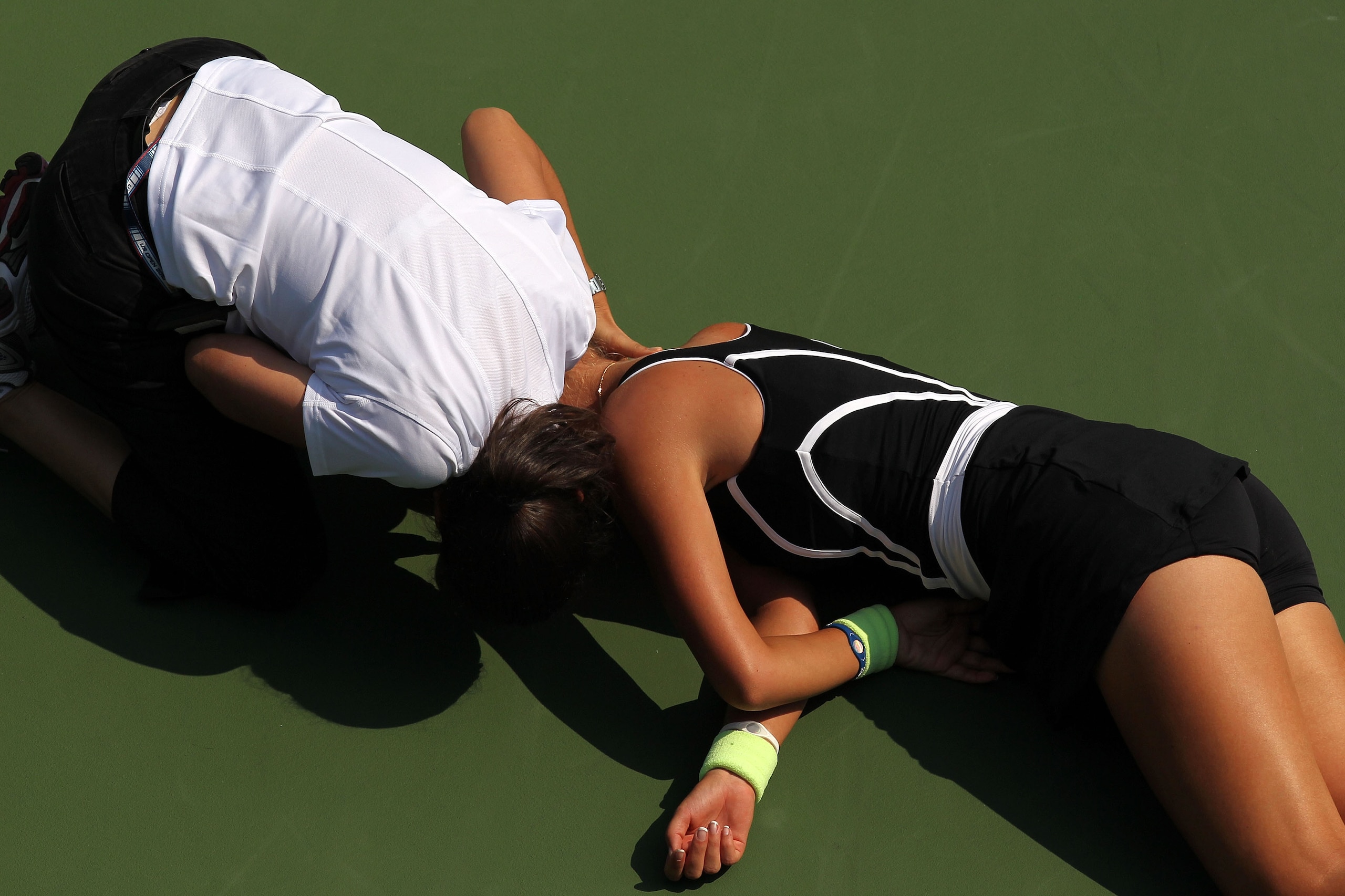 NEW YORK - SEPTEMBER 01:  Victoria Azarenka of Belarus is tended to by medical personnel on the court after she collapsed during her second round women's singles match against Gisela Dulko (seen standing at the bottom of the frame) of Argentina on day thr