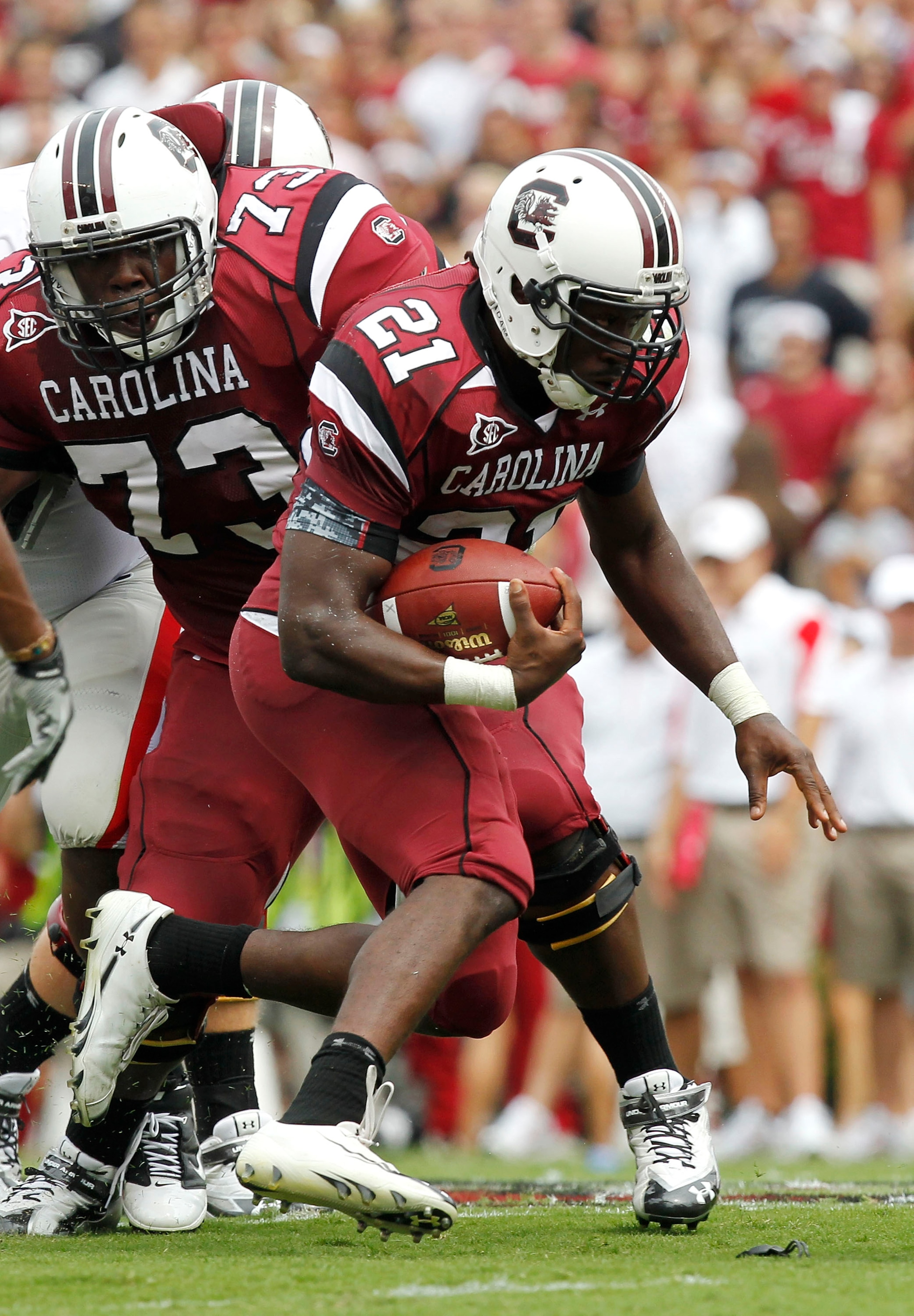 COLUMBIA, SC - SEPTEMBER 11: Tailback Marcus Lattimore #21 of the South Carolina Gamecocks runs with the ball while guard Rokevious Watkins #73 looks on during the game against the Georgia Bulldogs at Williams-Brice Stadium on September 11, 2010 in Columb COLUMBIA, SC - SEPTEMBER 11: Tailback Marcus Lattimore #21 of the South Carolina Gamecocks runs with the ball while guard Rokevious Watkins #73 looks on during the game against the Georgia Bulldogs at Williams-Brice Stadium on September 11, 2010 in Columb