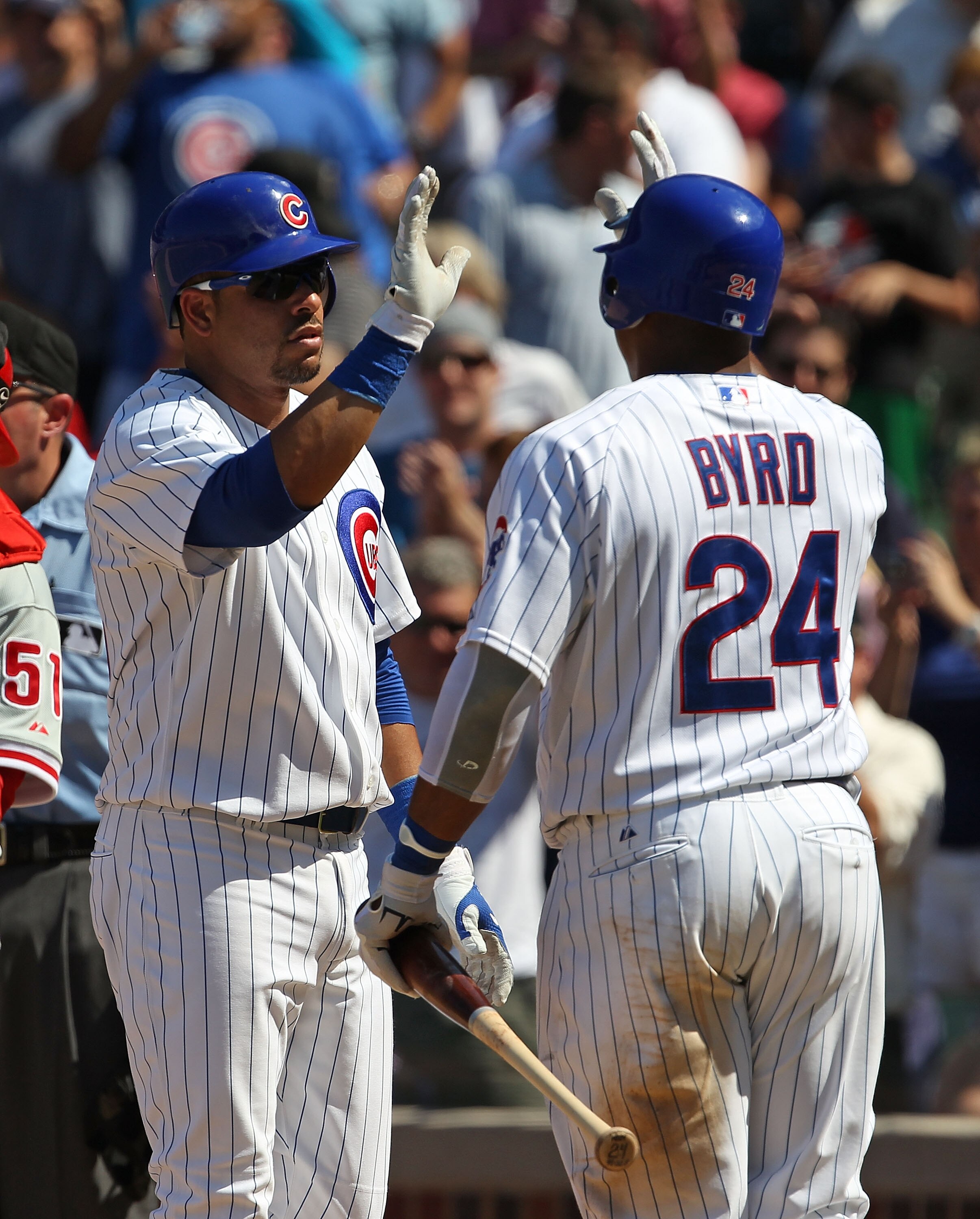 CHICAGO - JULY 16: Aramis Ramirez #16 of the Chicago Cubs is congratulated by teammate Marlon Byrd #24 after hitting the game-winning home run, a solo shot in the 8th inning, against the Philadelphia Phillies at Wrigley Field on July 16, 2010 in Chicago, 