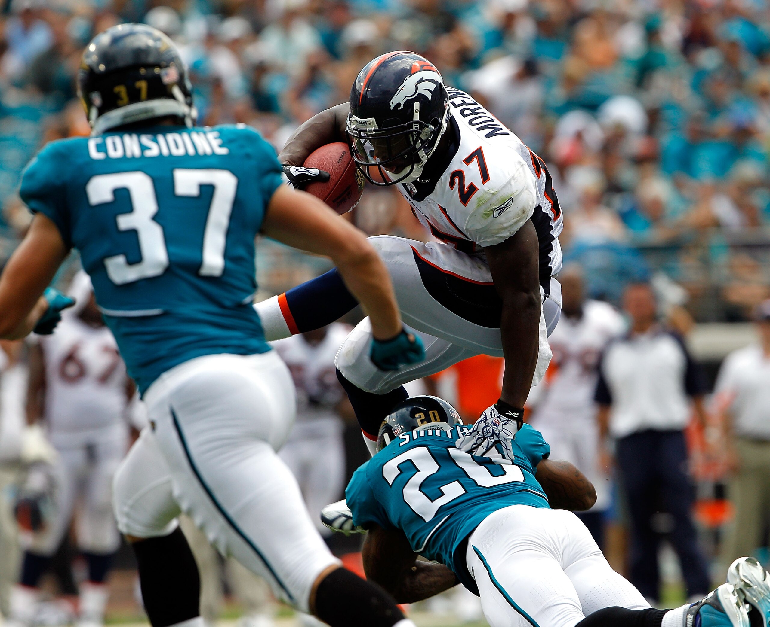 JACKSONVILLE, FL - SEPTEMBER 12:  Anthony Smith #20 of the Jacksonville Jaguars attempts to tackle Knowshon Moreno #27 of the Denver Broncos during the NFL season opener game at EverBank Field on September 12, 2010 in Jacksonville, Florida.  (Photo by Sam