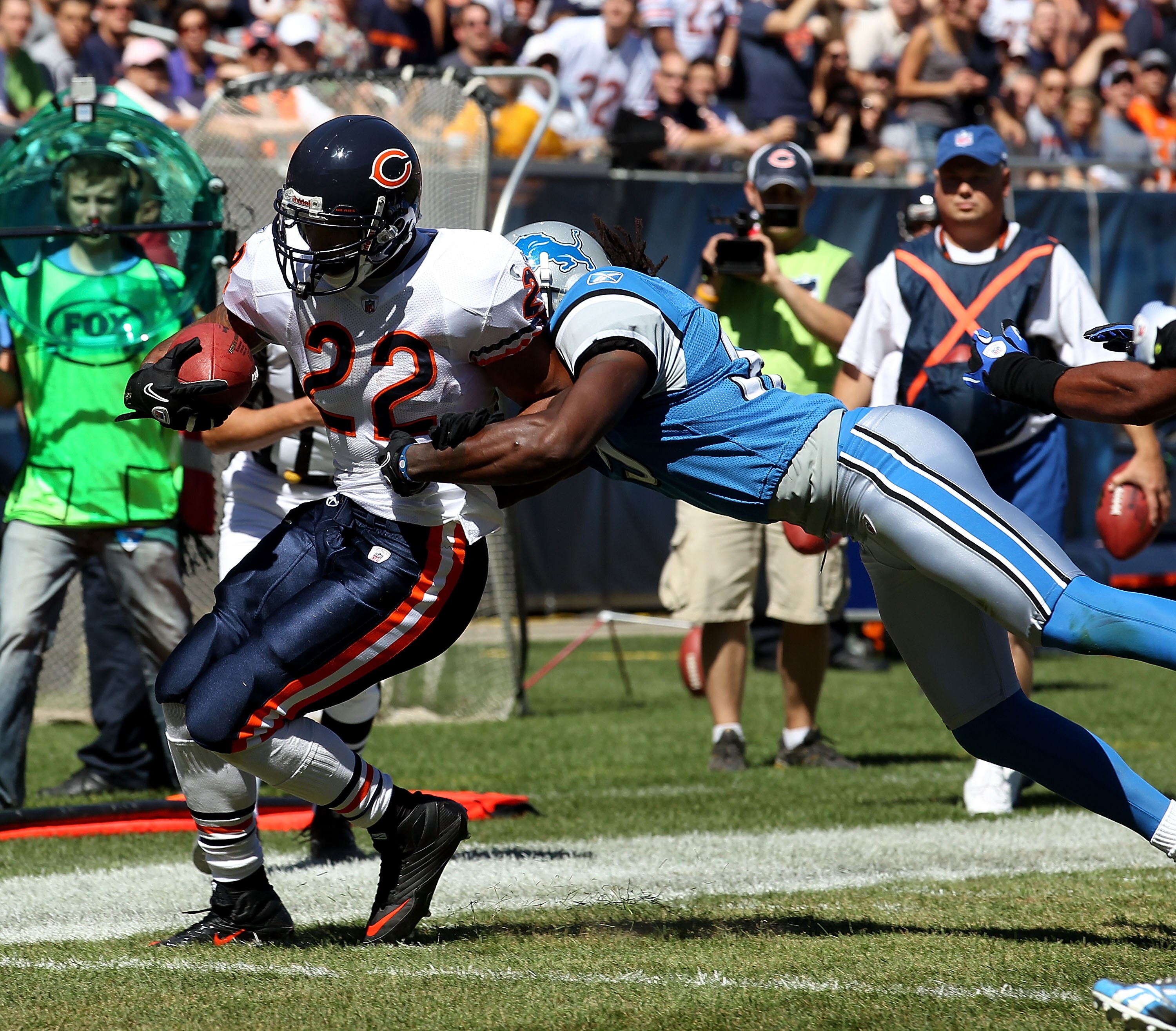 CHICAGO - SEPTEMBER 12: Matt Forte #22 of the Chicago Bears is hit by Aaron Beryy #32 of the Detroit Lions during the NFL season opening game at Soldier Field on September 12, 2010 in Chicago, Illinois. The Bears defeated the Lions 19-14. (Photo by Jonath
