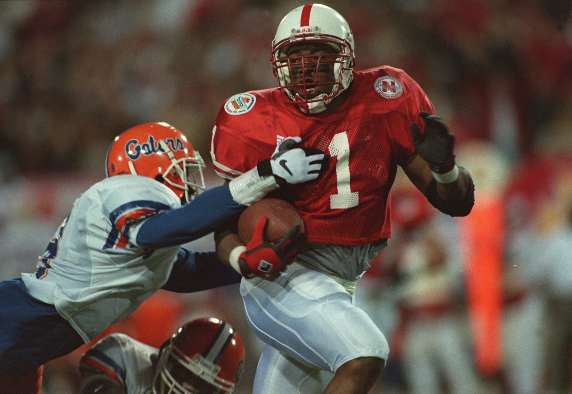 2 Jan 1996:  Running back Lawrence Phillips #1 of the Nebraska Cornhuskers breaks throught the attempted arm tackle by an unidentified Florida Gators defender during the Cornhuskers 62-54 victory over the Gators in the Fiesta Bowl at Sun Devil Stadium in
