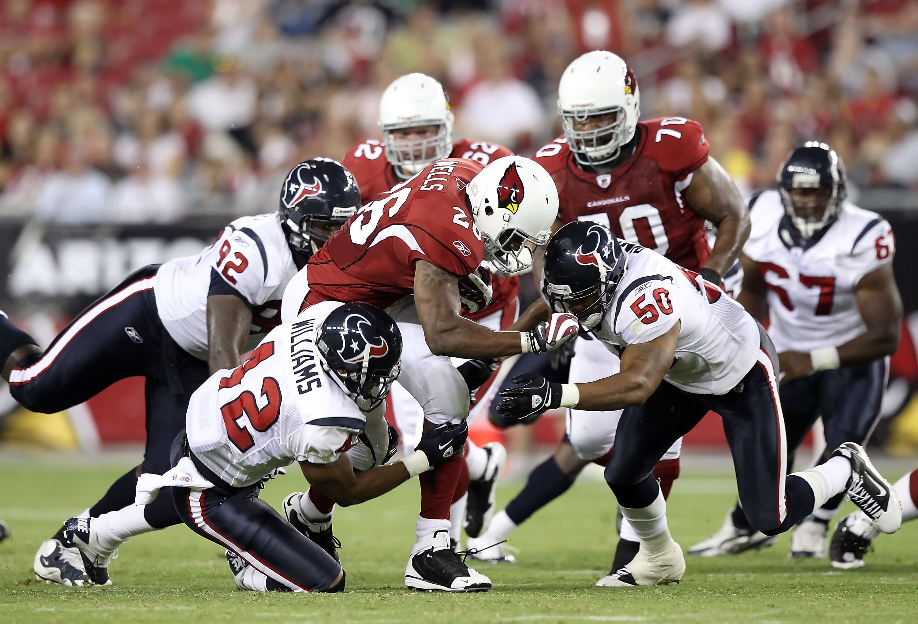 GLENDALE, AZ - AUGUST 14:  Runningback Beanie Wells #26 of the Arizona Cardinals rushes the ball against the Houston Texans during preseason NFL game at the University of Phoenix Stadium on August 14, 2010 in Glendale, Arizona.  The Cardinals defeated the
