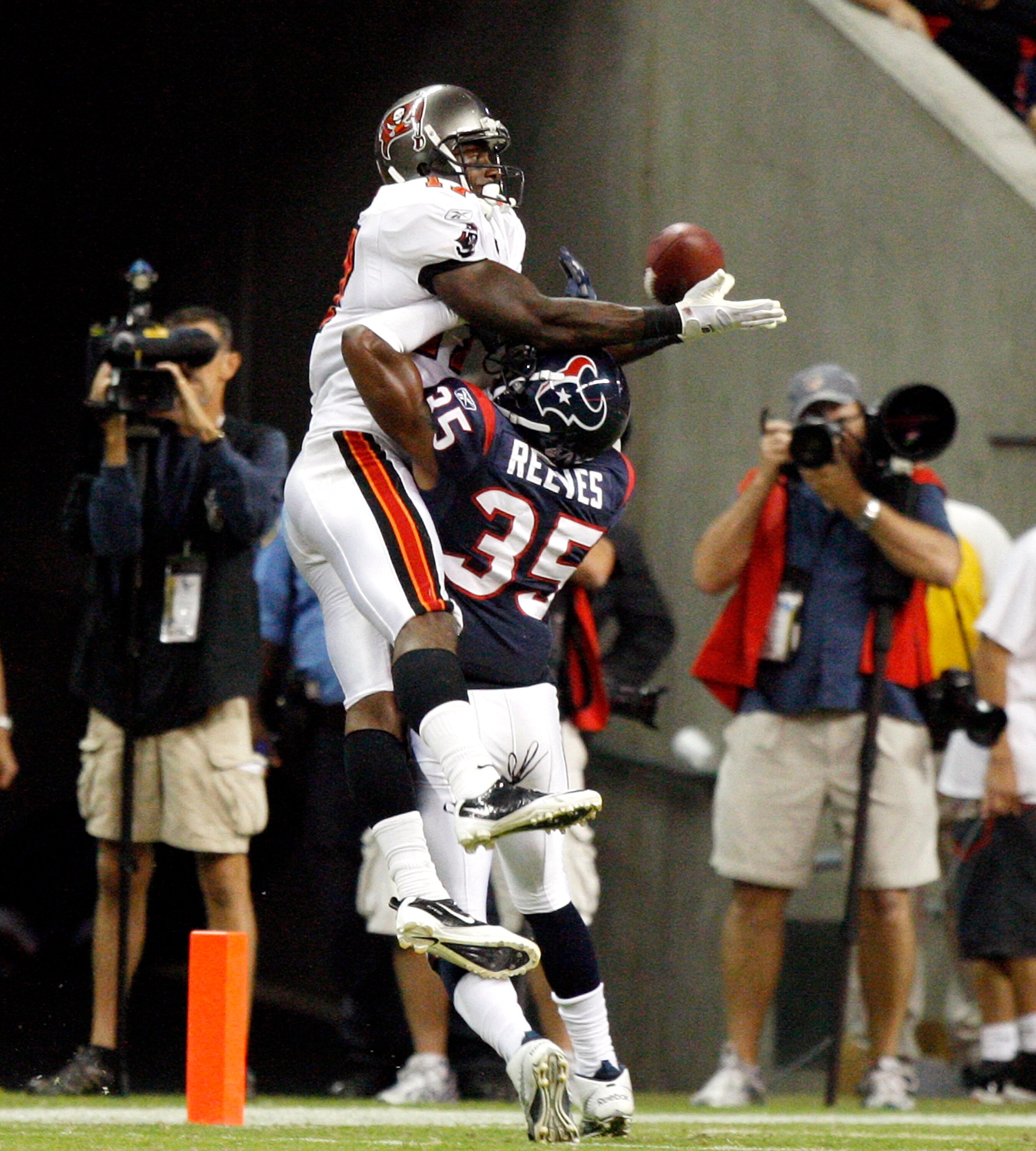 HOUSTON - SEPTEMBER 02: Wide receiver Arrelious Benn #17 of the Tampa Bay Buccaneers leaps over cornerback Jacques Reeves #35 of the Houston Texans for a touchdown in the fourth quarter at Reliant Stadium on September 2, 2010 in Houston, Texas. (Photo b HOUSTON - SEPTEMBER 02: Wide receiver Arrelious Benn #17 of the Tampa Bay Buccaneers leaps over cornerback Jacques Reeves #35 of the Houston Texans for a touchdown in the fourth quarter at Reliant Stadium on September 2, 2010 in Houston, Texas. (Photo b