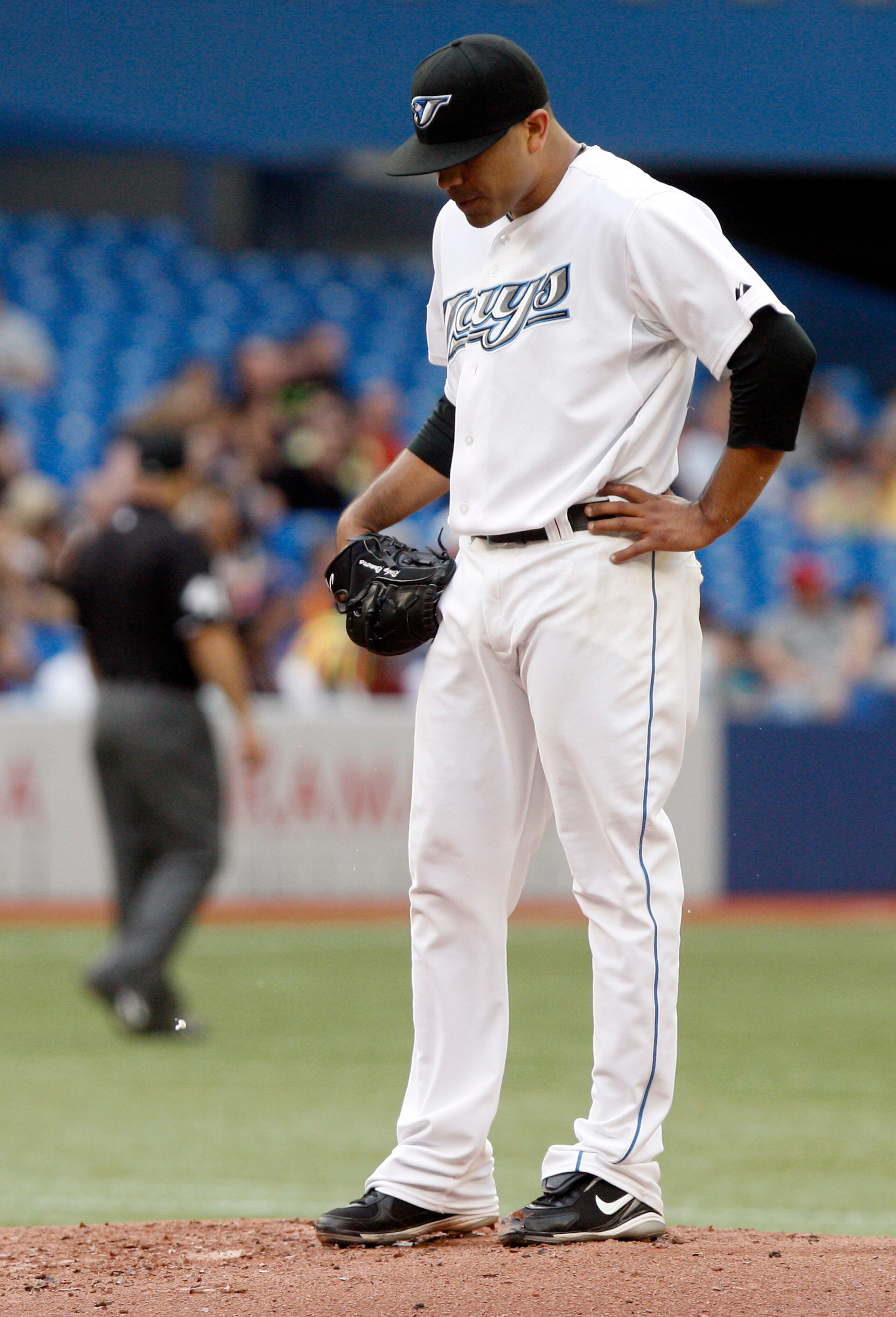 TORONTO - JULY 9: Ricky Romero #24 of the Toronto Blue Jays regroups after the 5th run of the inning against the Boston Red Sox rounds the bases after a 2 run home run by Bill Hall during a MLB game at The Rogers Centre on  July 9, 2010 in Toronto, Ontari