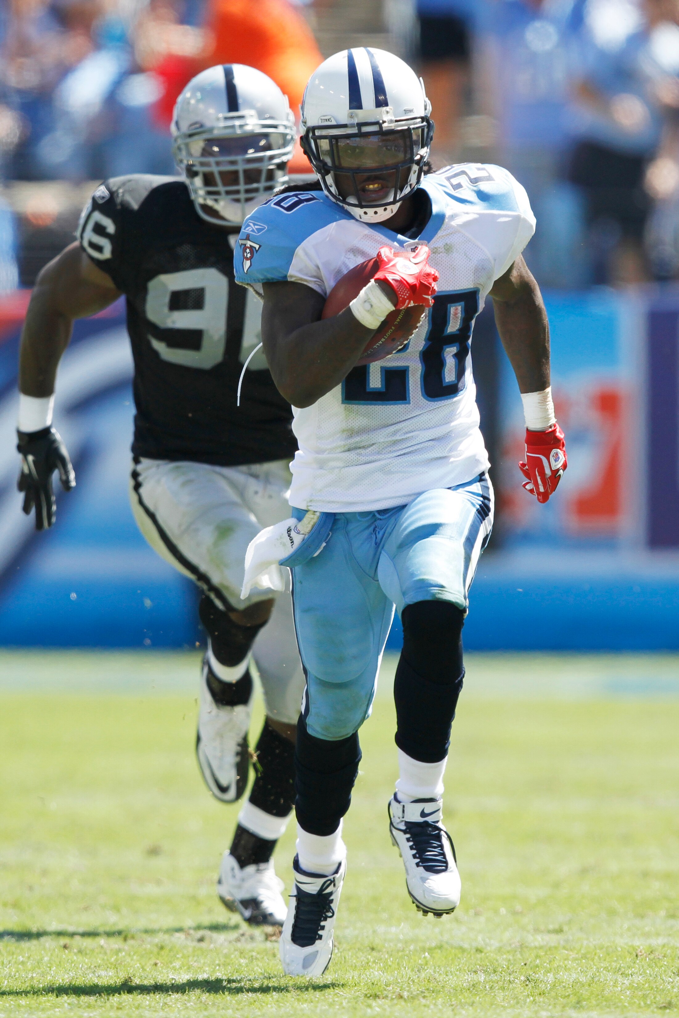 NASHVILLE - SEPTEMBER 12: Chris Johnson #28 of the Tennessee Titans outruns Kamerion Wimbley #96 of the Oakland Raiders for a 76-yard touchdown in the first half of the NFL season opener at LP Field on September 12, 2010 in Nashville, Tennessee. (Photo by
