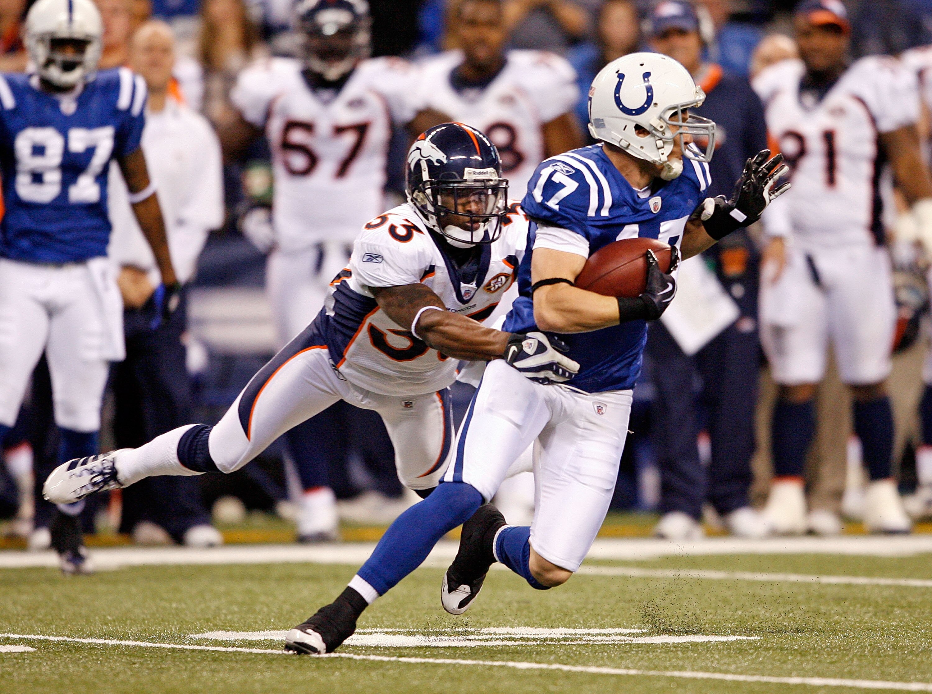 INDIANAPOLIS - DECEMBER 13:  Austin Collie #17 of the Indianapolis Colts runs against Alphonso Smith #33 of the Denver Broncos during the NFL game at Lucas Oil Stadium on December 13, 2009 in Indianapolis, Indiana. The Colts won 28-16.  (Photo by Andy Lyo