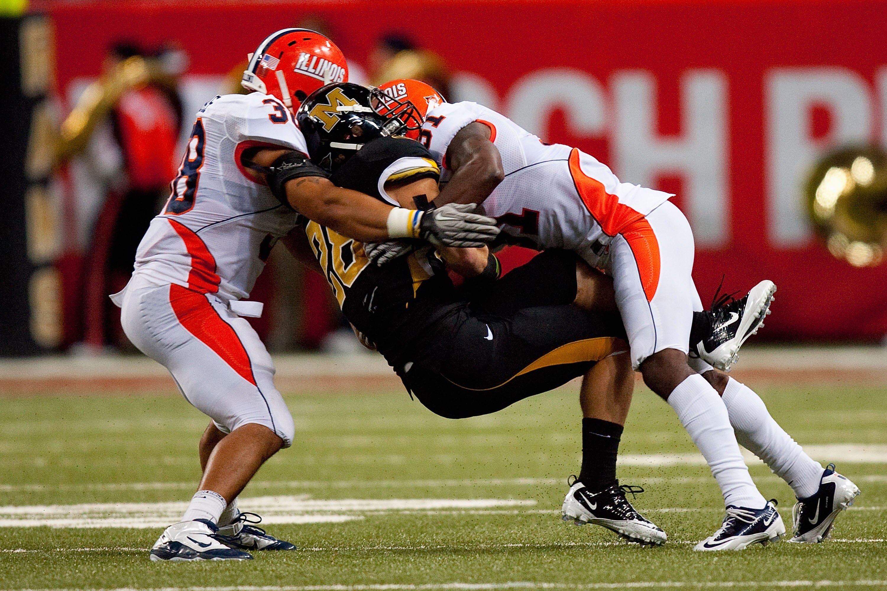 ST. LOUIS - SEPTEMBER 4: Travon Bellamy #31 and Ian Thomas #38 both of the University of Illinois Fighting Illini tackle T.J. Moe #28 of the University of Missouri Tigers during the State Farm Arch Rivalry game on September 4, 2010 at the Edward Jones Dom