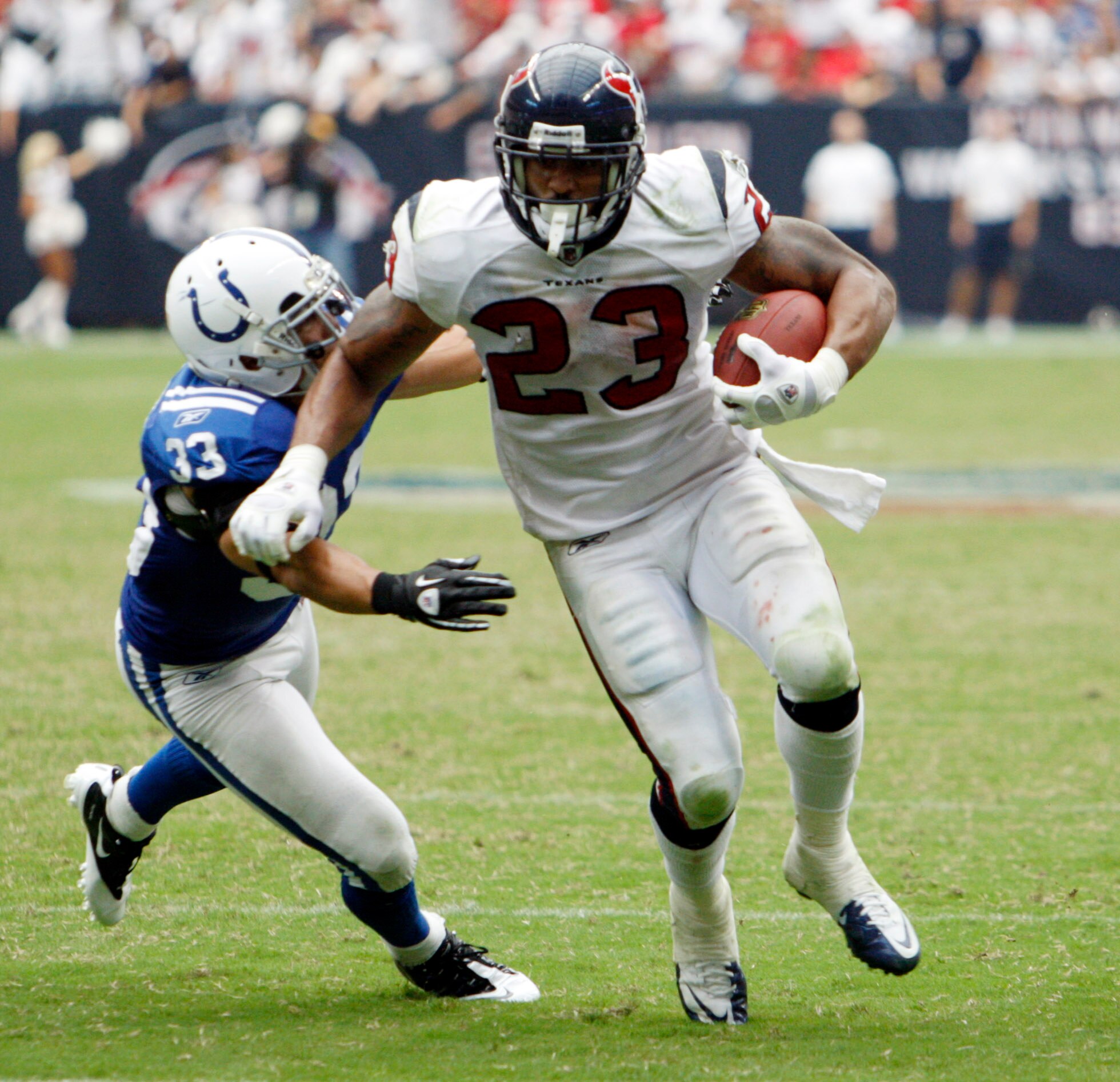 HOUSTON - SEPTEMBER 12:  Running back Arian Foster #23 of the Houston Texans avoids a tackle by defensive back Melivn Bullitt #33 of the Indianapolis Colts during the NFL season opener at Reliant Stadium on September 12, 2010 in Houston, Texas.  (Photo by