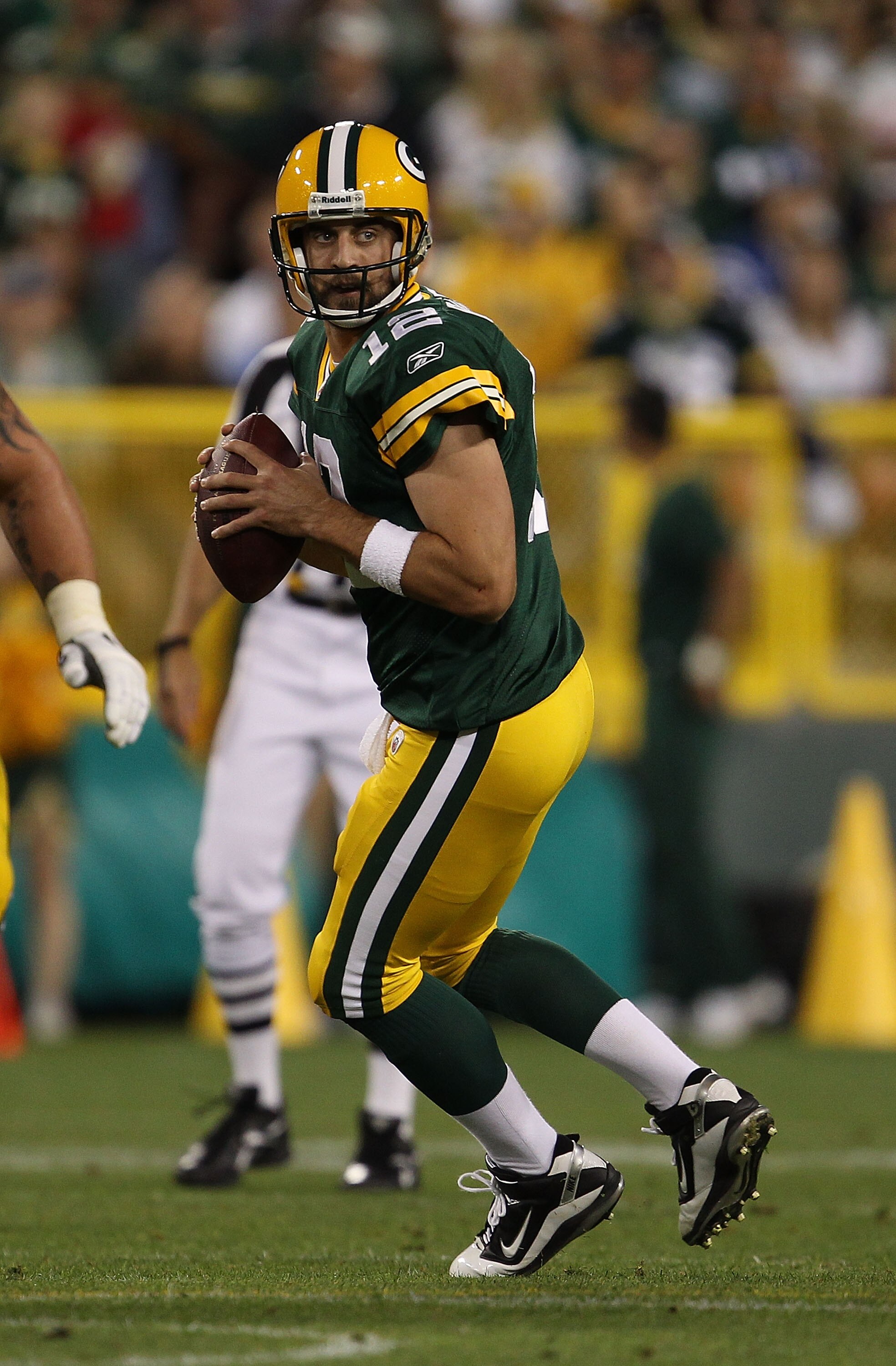 GREEN BAY, WI - AUGUST 26: Aaron Rodgers #12 of the Green Bay Packers looks for a receiver against the Indianapolis Colts during a preseason game at Lambeau Field on August 26, 2010 in Green Bay, Wisconsin. The Packers defeated the Colts 59-24.  (Photo by