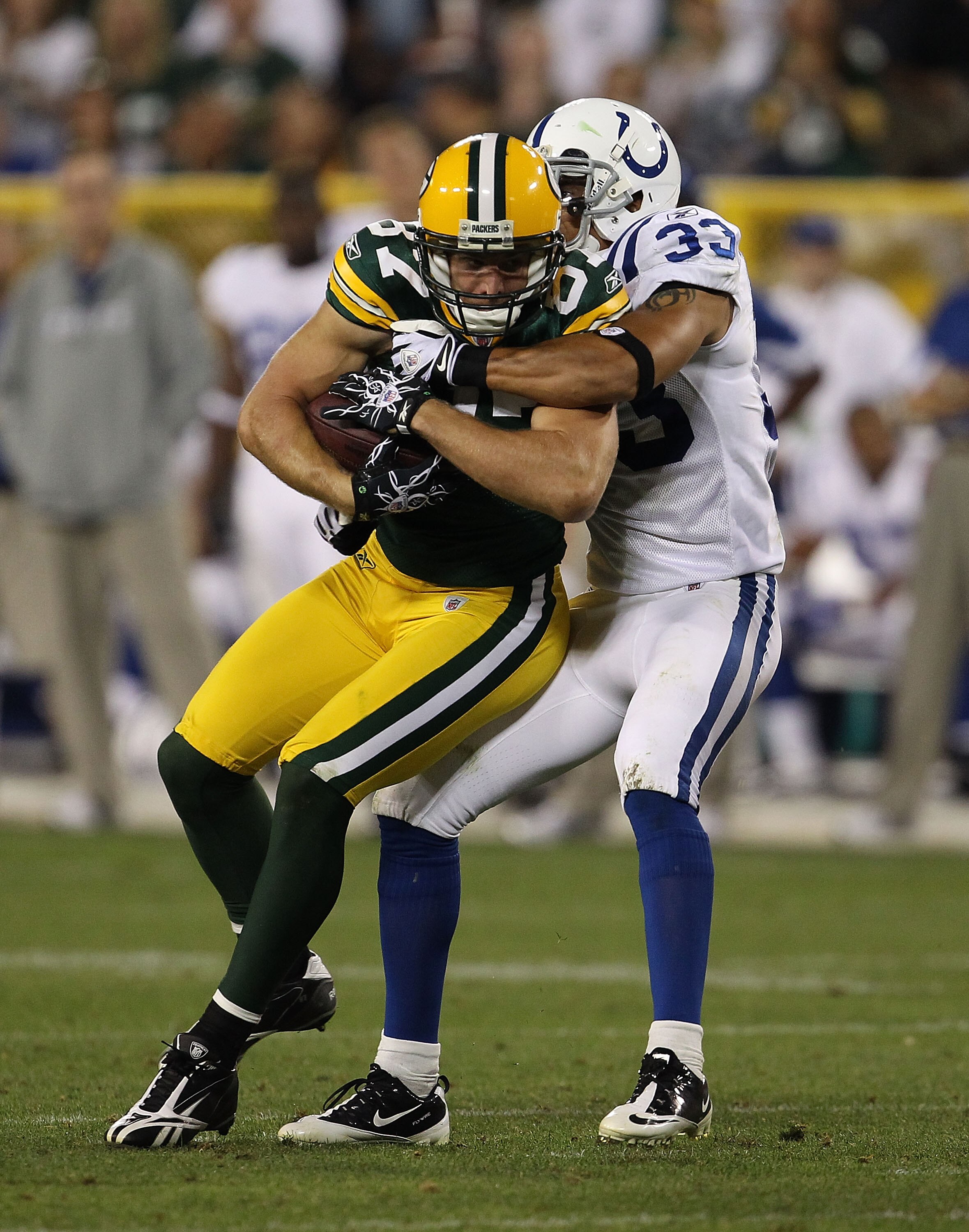GREEN BAY, WI - AUGUST 26: Jordy Nelson #87 of the Green Bay Packers is tackled by Melvin Bullitt #33 of the Indianapolis Colts during a preseason game at Lambeau Field on August 26, 2010 in Green Bay, Wisconsin. The Packers defeated the Colts 59-24.  (Ph