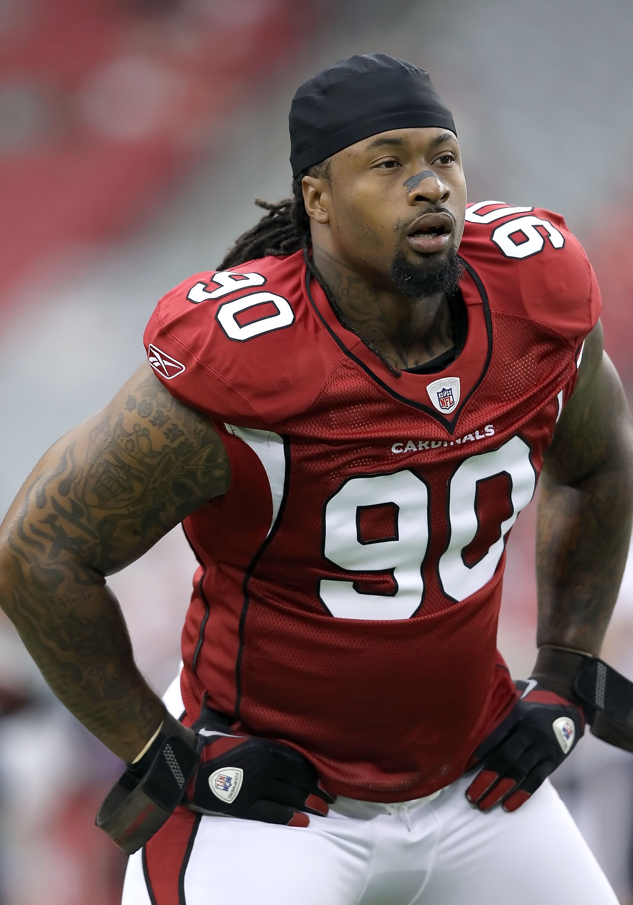 GLENDALE, AZ - AUGUST 14:  Defensive tackle Darnell Dockett #90 of the Arizona Cardinals warms up before the preseason NFL game against the Houston Texans at the University of Phoenix Stadium on August 14, 2010 in Glendale, Arizona.  The Cardinals defeate