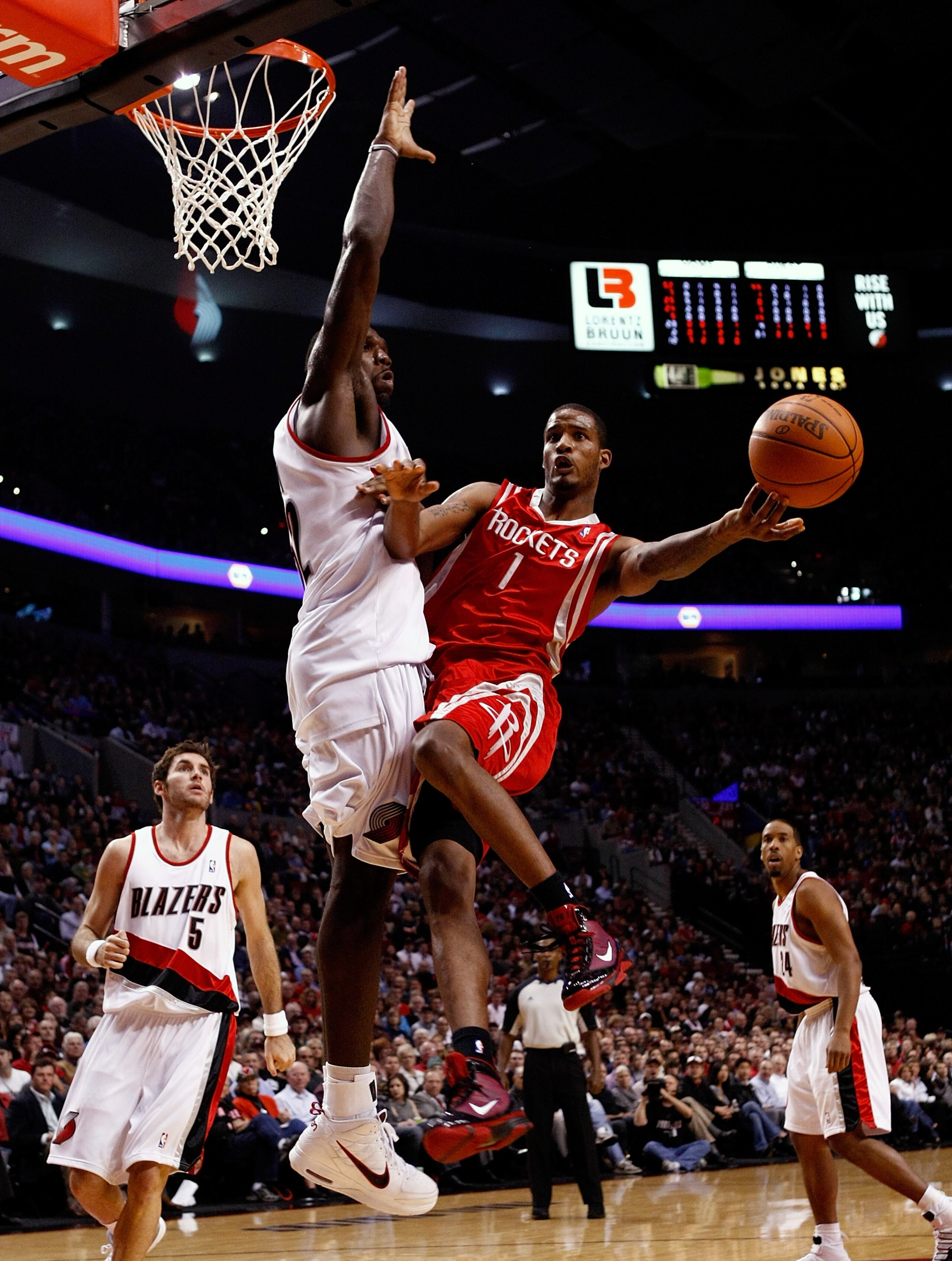 PORTLAND, OR - OCTOBER 27:  Trevor Ariza #1 of the Houston Rockets is guarded by Greg Oden #52 of the Portland Trail Blazers during the season opener on October 27, 2009 at the Rose Garden in Portland, Oregon. NOTE TO USER: User expressly acknowledges and