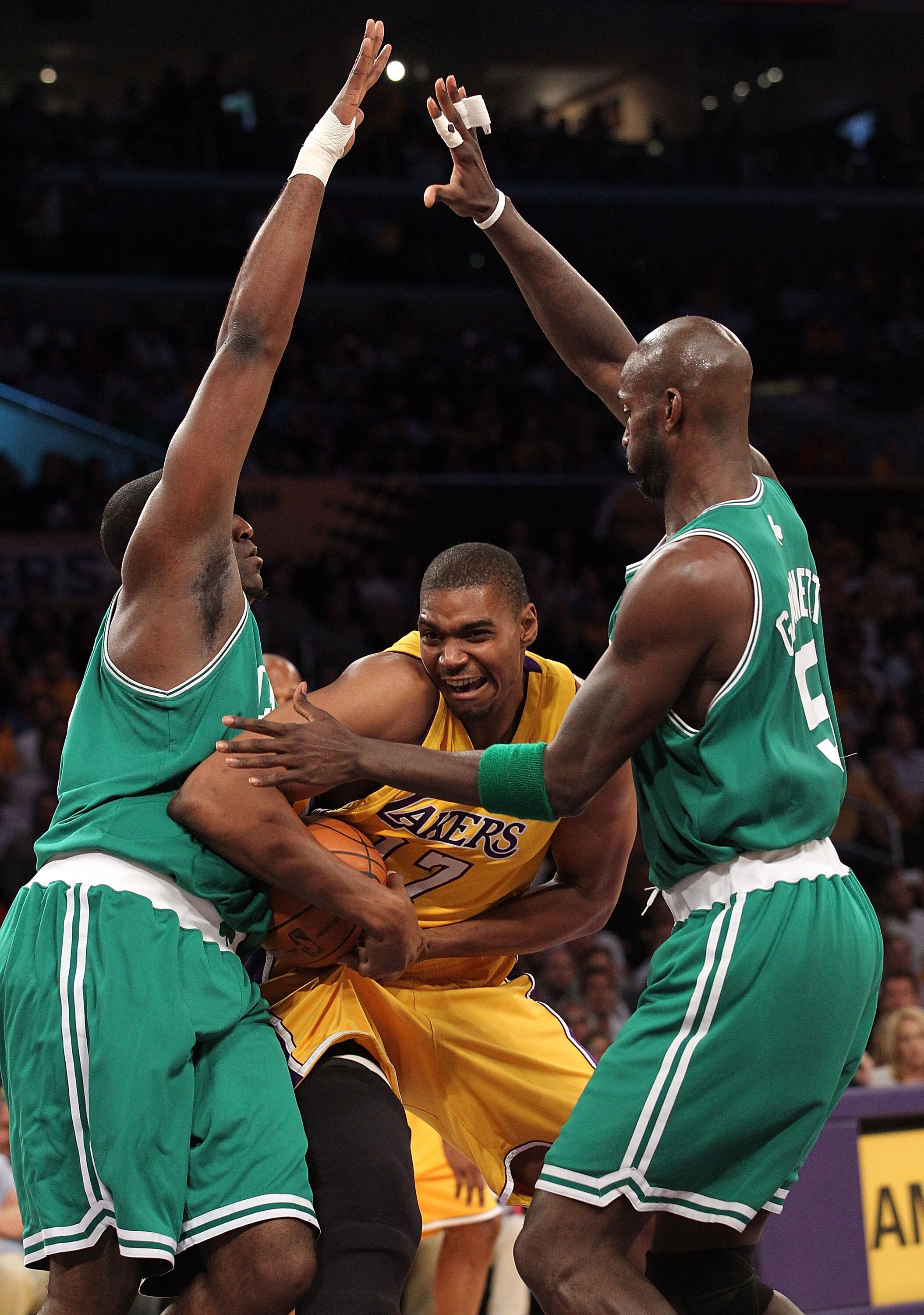 LOS ANGELES, CA - JUNE 15: Andrew Bynum #17 of the Los Angeles Lakers drives through Kendrick Perkins #43 and Kevin Garnett #5 of the Boston Celtics in the first period of Game Six of the 2010 NBA Finals at Staples Center on June 15, 2010 in Los Angeles, LOS ANGELES, CA - JUNE 15: Andrew Bynum #17 of the Los Angeles Lakers drives through Kendrick Perkins #43 and Kevin Garnett #5 of the Boston Celtics in the first period of Game Six of the 2010 NBA Finals at Staples Center on June 15, 2010 in Los Angeles,