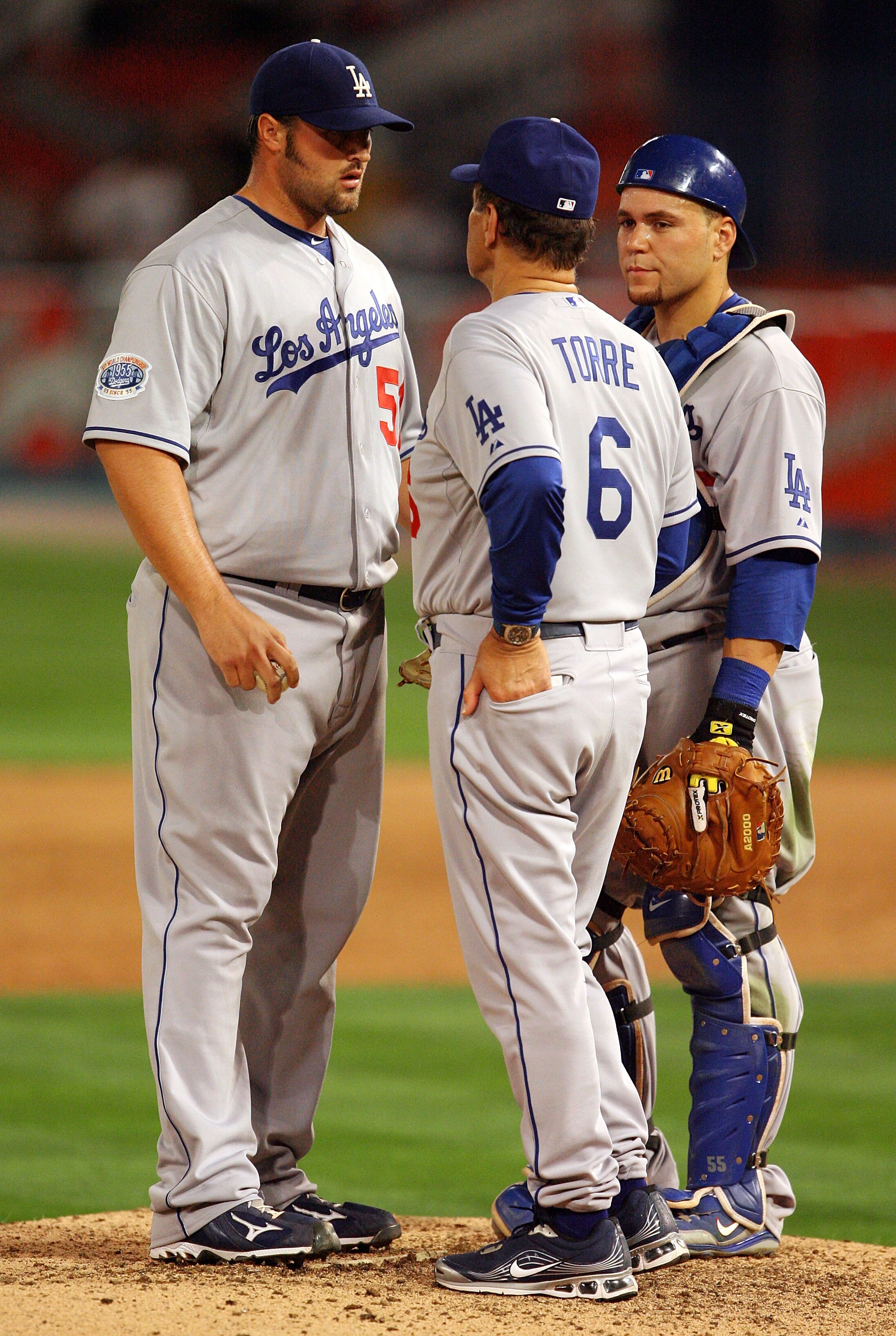 MIAMI - APRIL 09:  Relief pitcher Jonathan Broxton #51 of the Los Angeles Dodgers talks with manager Joe Torre and catcher Russell Martin #55 before pitching in the ninth inning against the Florida Marlins during the Marlins home opening game at Sun Life