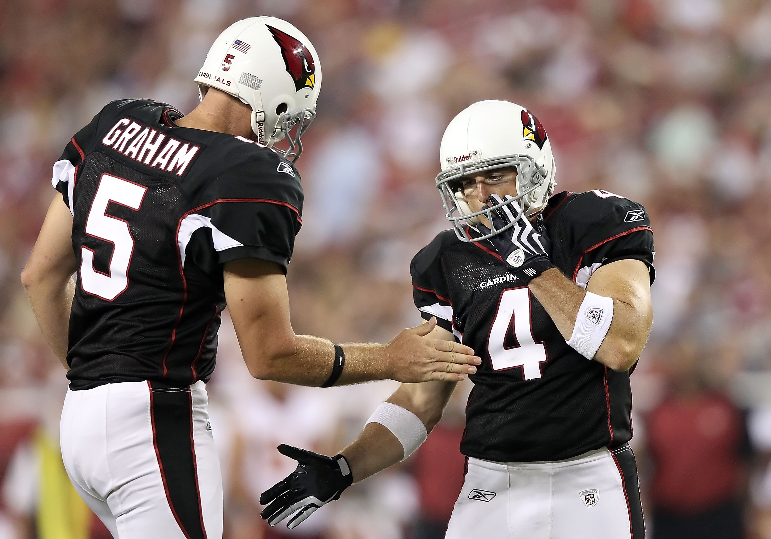 GLENDALE, AZ - SEPTEMBER 02:  Kicker Jay Feely #4 of the Arizona Cardinals high fives teammate Ben Graham #5 after kicking a 22 yard field goal during the third quarter of the preseason NFL game against the Washington Redskins at the University of Phoenix