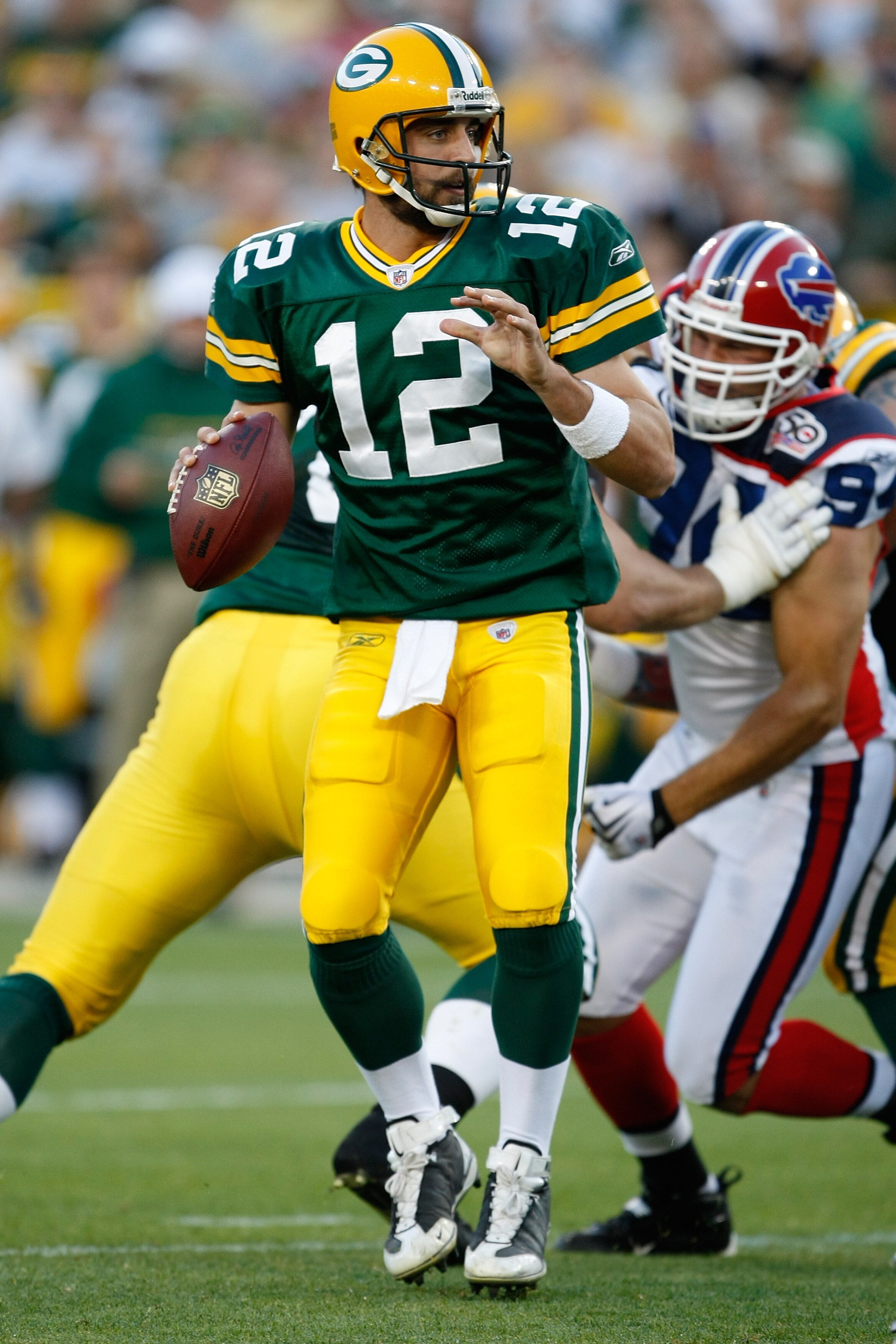GREEN BAY, WI - AUGUST 22: Quarterback Aaron Rogers #12 of the Green Bay Packers drops back to pass the football against the Buffalo Bills at Lambeau Field on August 22, 2009 in Green Bay. Wisconsin.  (Photo by Scott Boehm/Getty Images)
