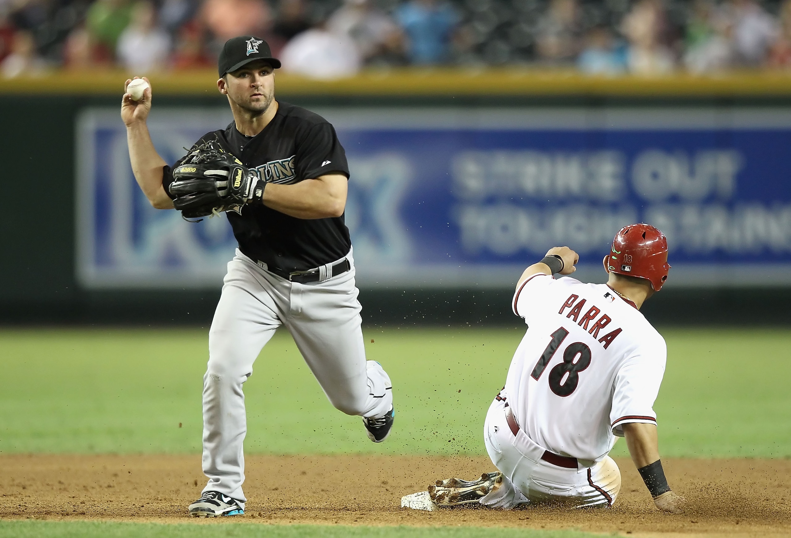 PHOENIX - JULY 08:  Infielder Dan Uggla #6 of the Florida Marlins gets the force out at second base on Gerardo Parra #18 of the Arizona Diamondbacks during the Major League Baseball game at Chase Field on July 8, 2010 in Phoenix, Arizona. The Diamondbacks