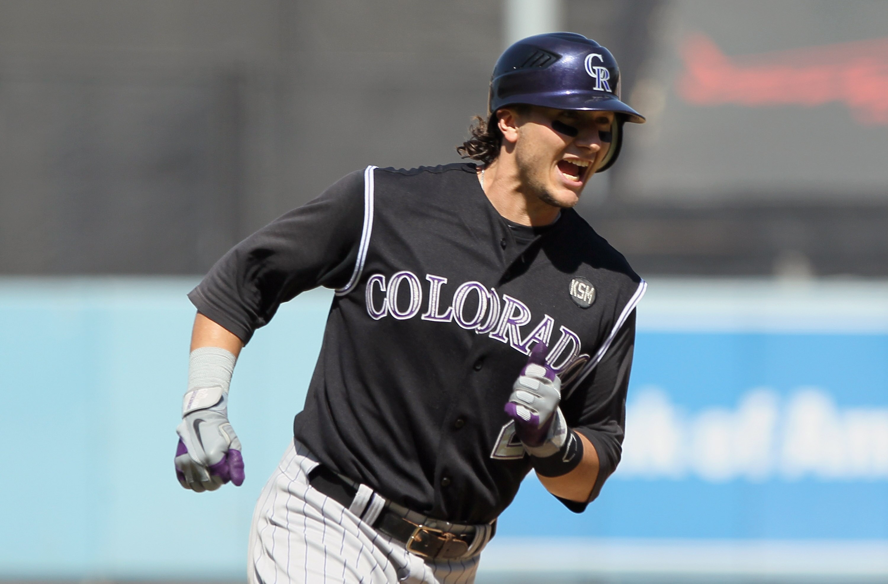LOS ANGELES, CA - SEPTEMBER 18:  Troy Tulowitzki #2 of the Colorado Rockies celebrates as he rounds third base after hitting his second two-run home run of the game against the Los Angeles Dodgers in the fifth inning at Dodger Stadium on September 18, 201