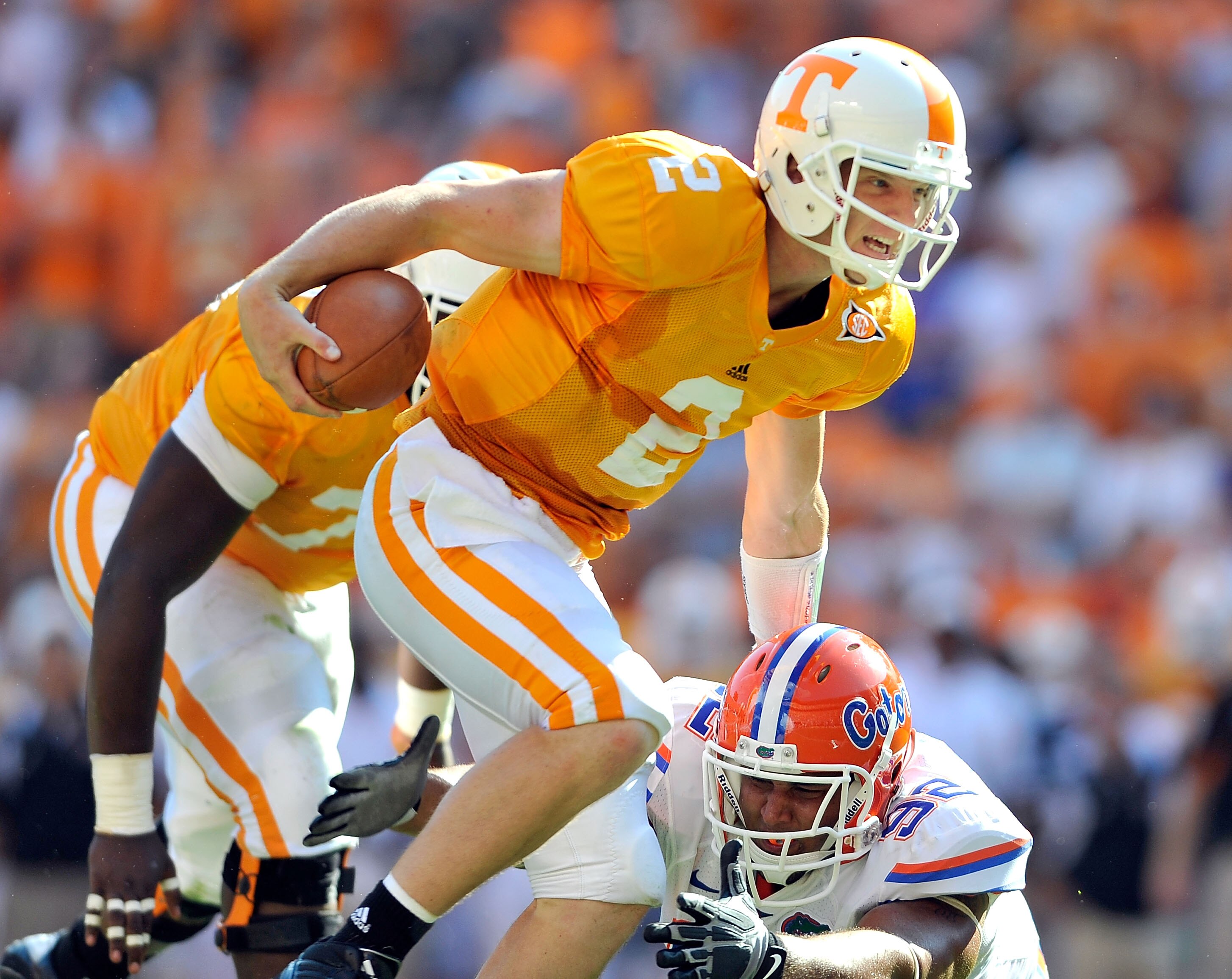 KNOXVILLE, TN - SEPTEMBER 18:  Quarterback Matt Simms #2 of the Tennessee Volunteers scrambles away from Terron Sanders #92 of the Florida Gators  during the first half at Neyland Stadium on September 18, 2010 in Knoxville, Tennessee.  (Photo by Grant Hal