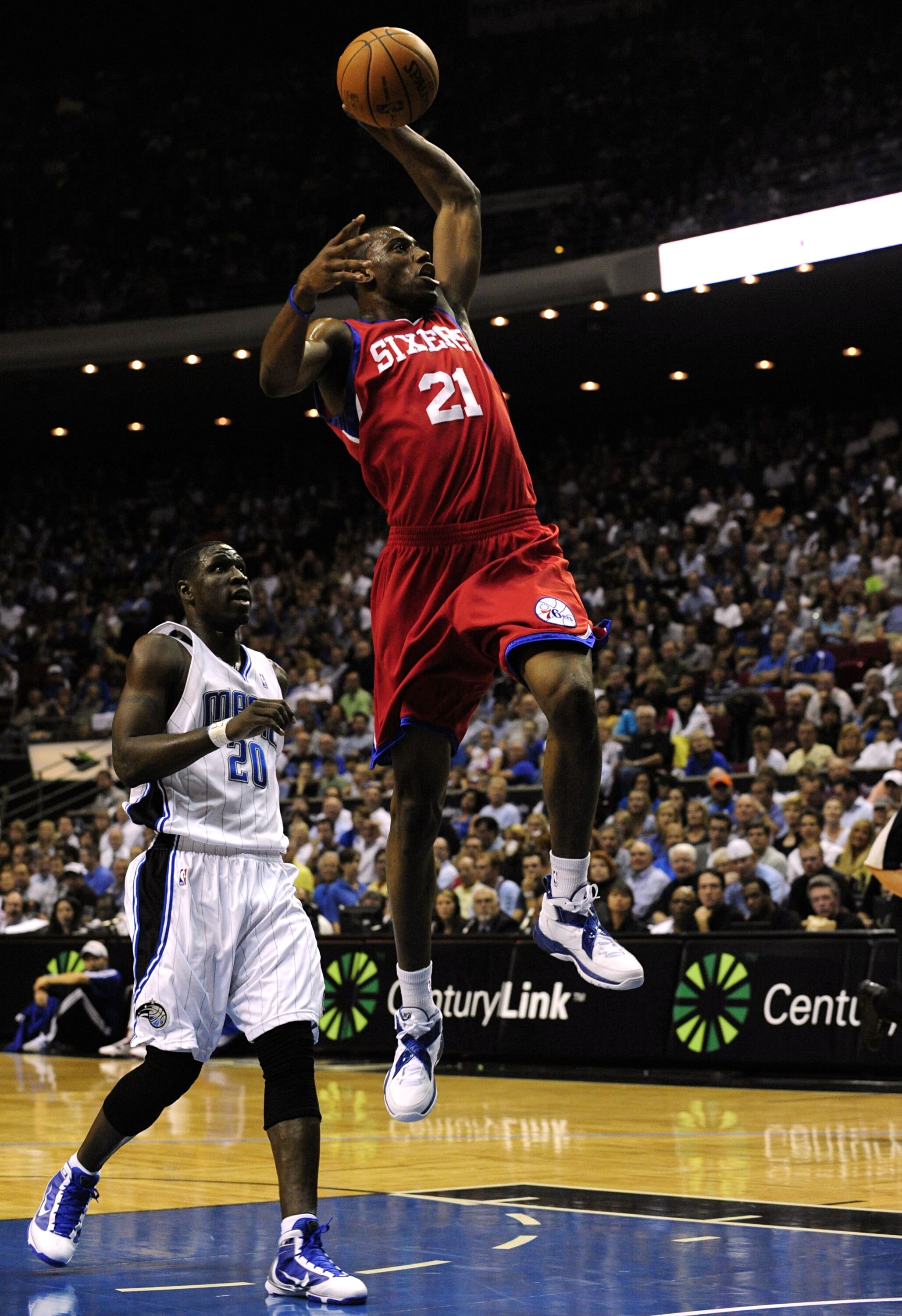 ORLANDO, FL - OCTOBER 28:  Thaddeus Young #21 of the Philadelphia 76ers goes to the basket over Mickael Pietrus #20 of the Orlando Magic during the game on October 28, 2009 at Amway Arena in Orlando, Florida.  NOTE TO USER: User expressly acknowledges and