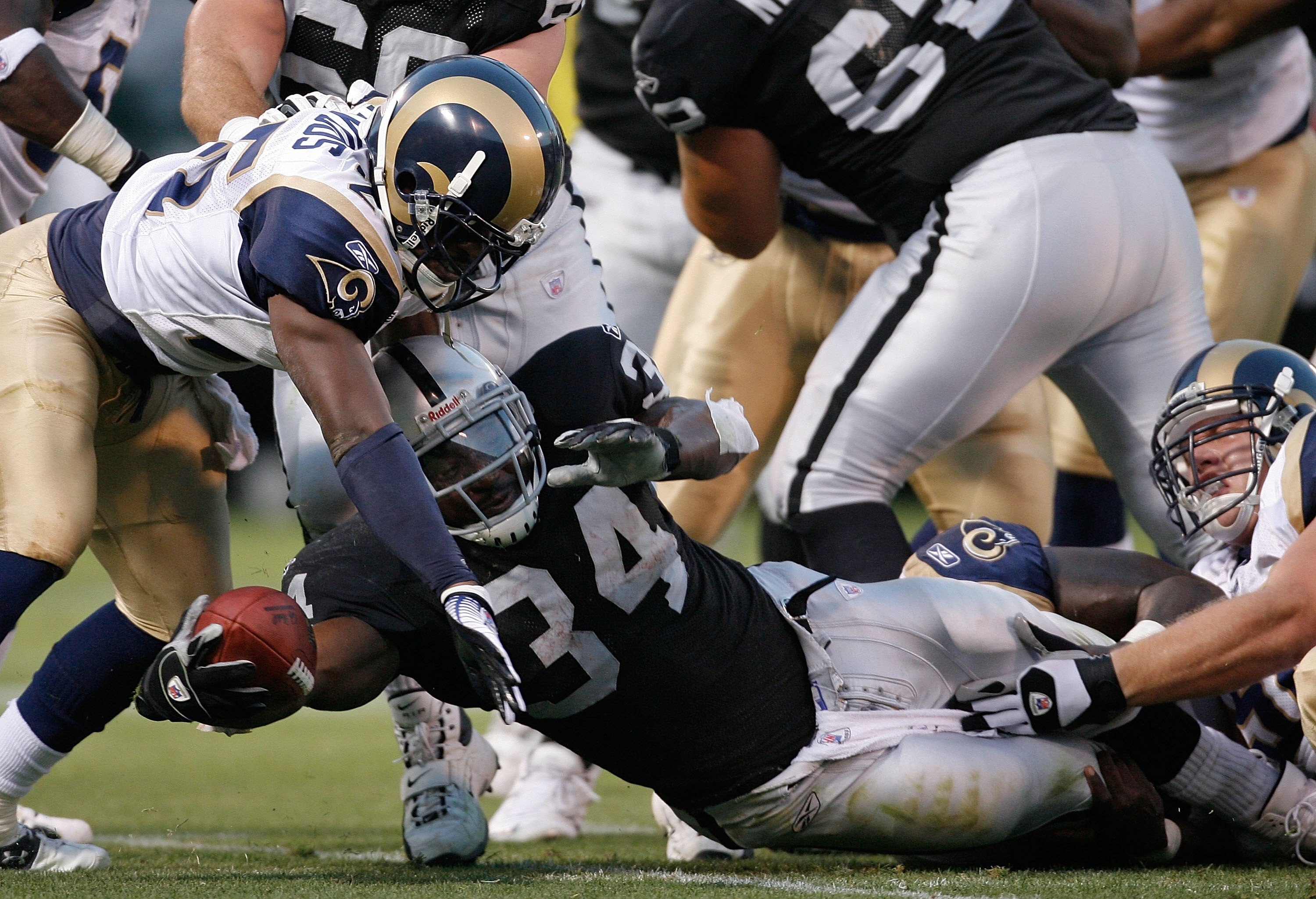 OAKLAND, CA - AUGUST 24:  Running back LaMont Jordan #34 of the Oakland Raiders is tackled by Corey Chavous #25 of the St. Louis Rams during a preseason game on August 24, 2007 at McAfee Coliseum.  (Photo by Greg Trott/Getty Images)