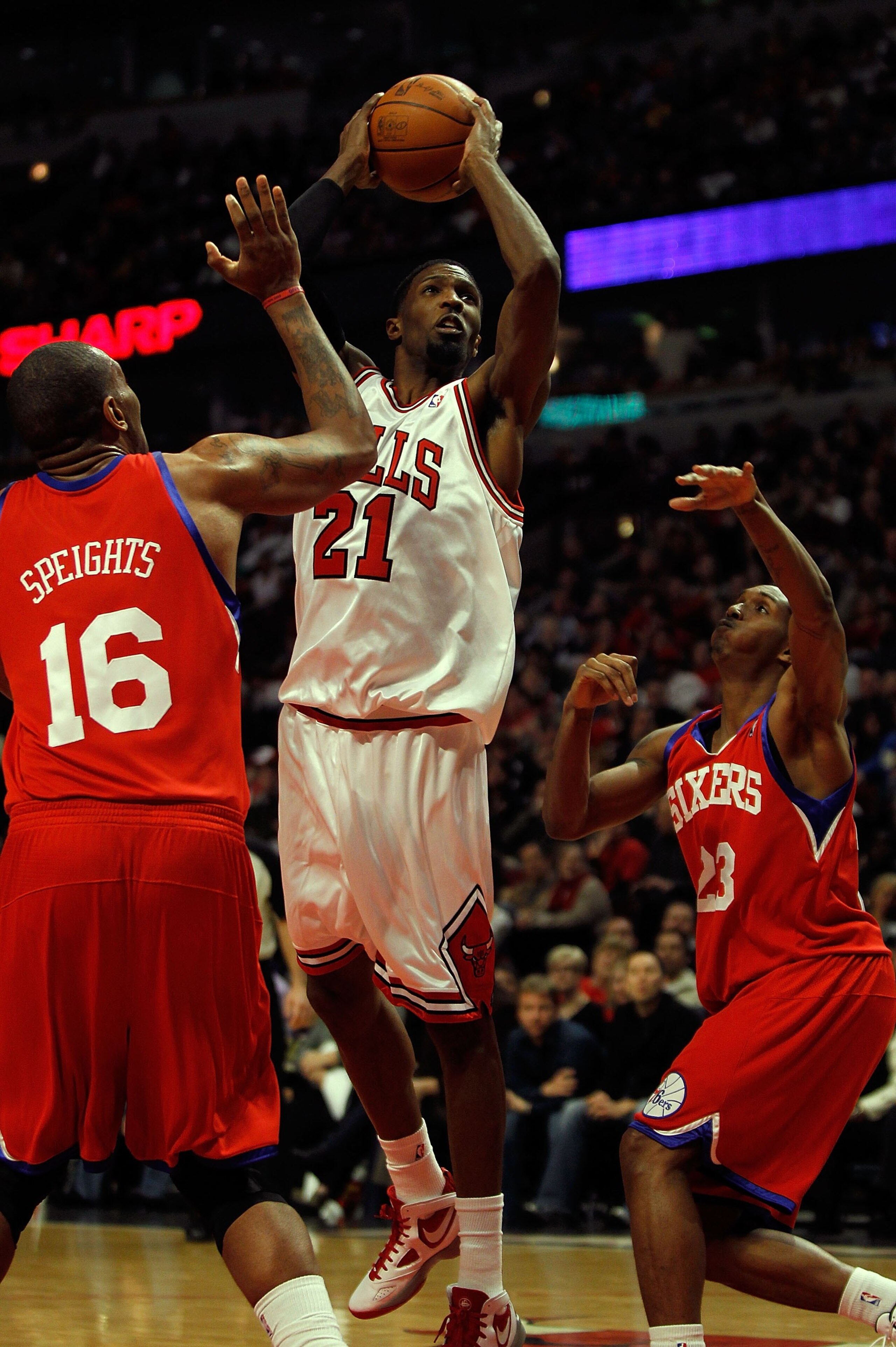 CHICAGO - FEBRUARY 20: Hakim Warrick #21 of the Chicago Bulls puts up a shot against Marreese Speights #16 and Louis Williams #23 of the Philadelphia 76ers at the United Center on February 20, 2010 in Chicago, Illinois. The Bulls defeated the 76ers 122-90