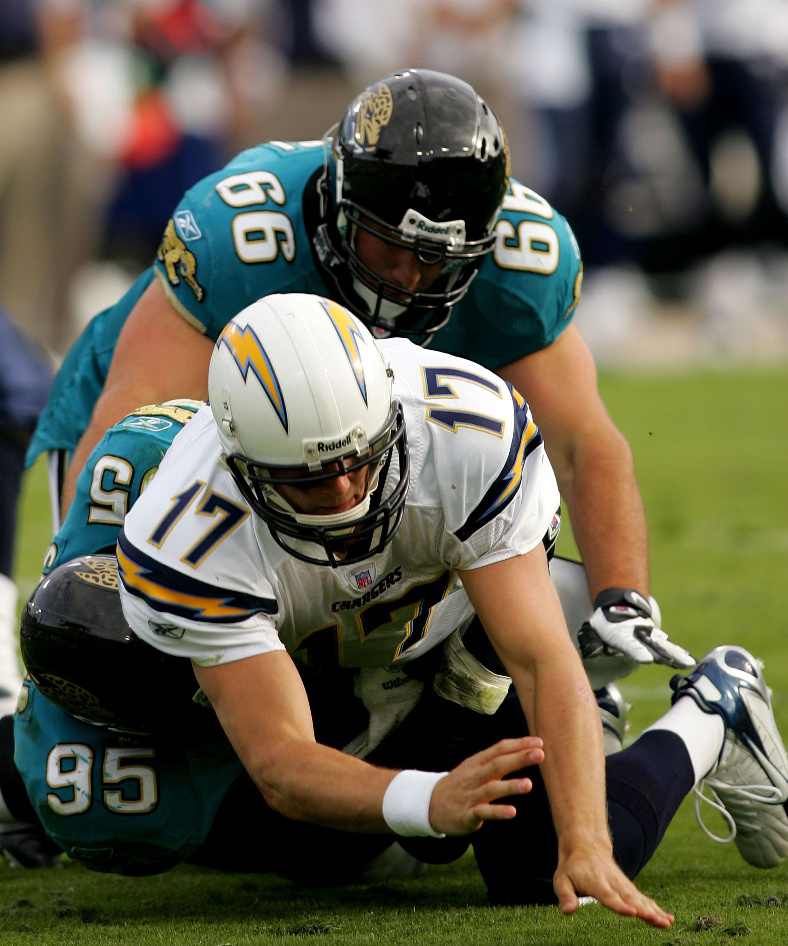 JACKSONVILLE, FL - NOVEMBER 18:  Philip Rivers #17 of the San Diego Chargers is sacked by Paul Spicer #95 and Derek Landiri #66 of the Jacksonville Jaguars at Jacksonville Municipal Stadium on November 18, 2007 in Jacksonville, Florida.  (Photo by Sam Gre