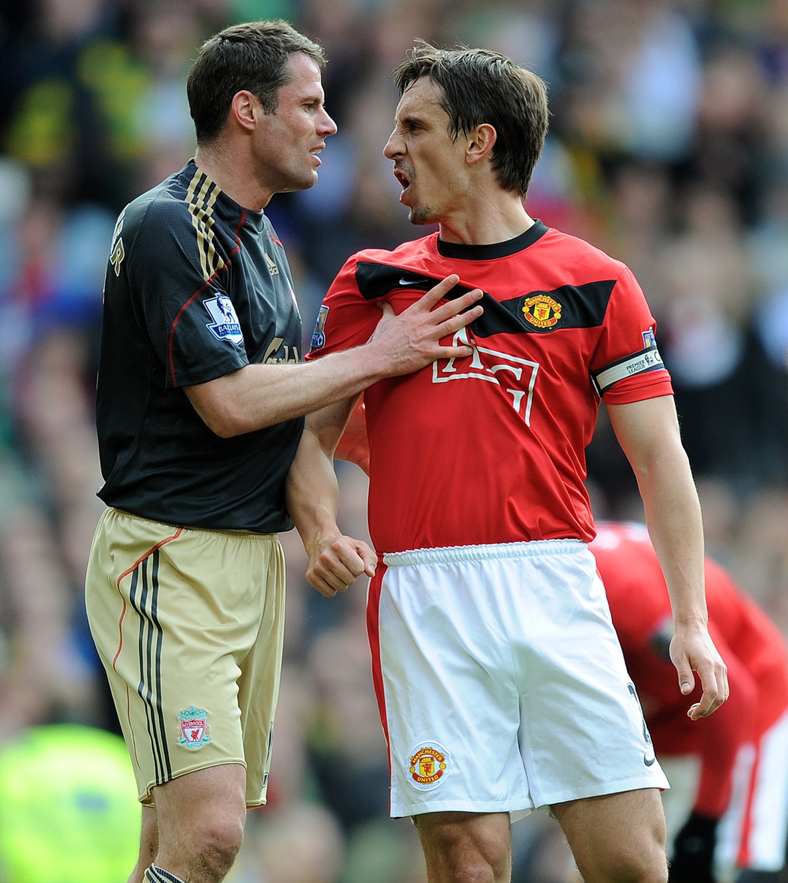 MANCHESTER, ENGLAND - MARCH 21: Jamie Carragher (L) of Liverpool argues with Gary Neville of Manchester United after United were awarded a penalty in the first half of the Barclays Premier League match between Manchester United and Liverpool at Old Traffo